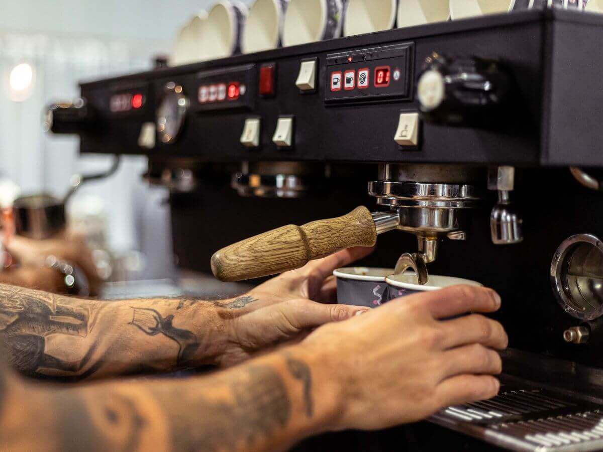 Extracting espresso from black La Marzocco Linea at event