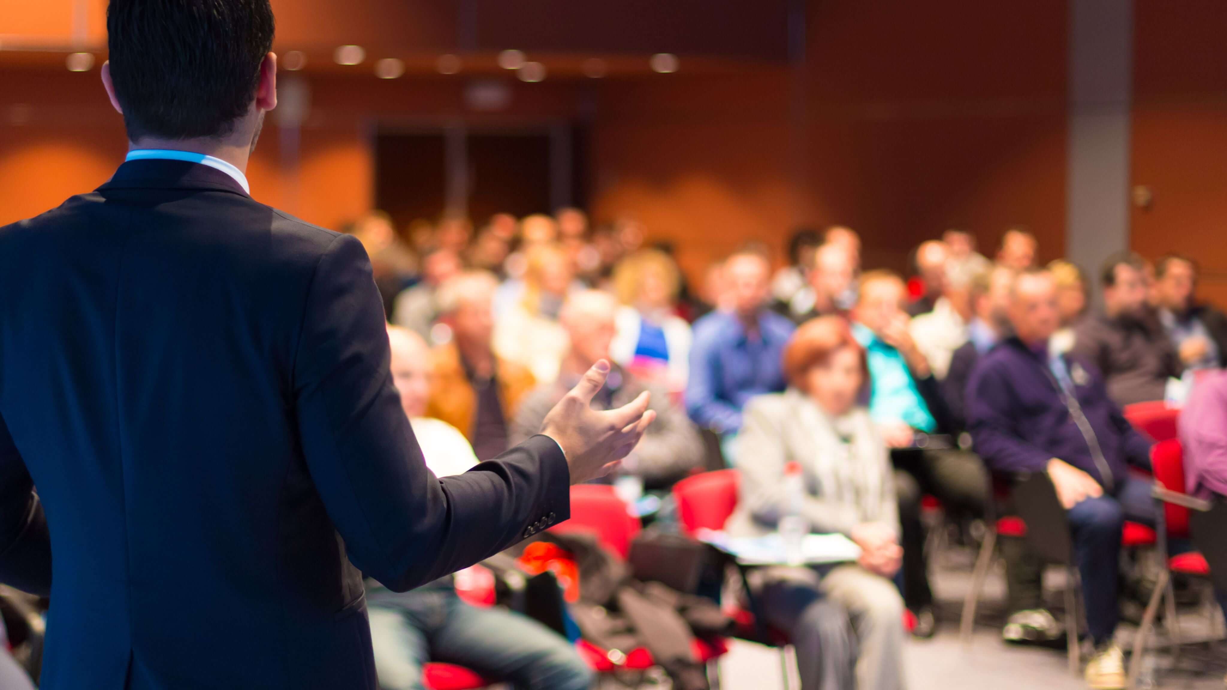 Speaker presenting to conference attendees