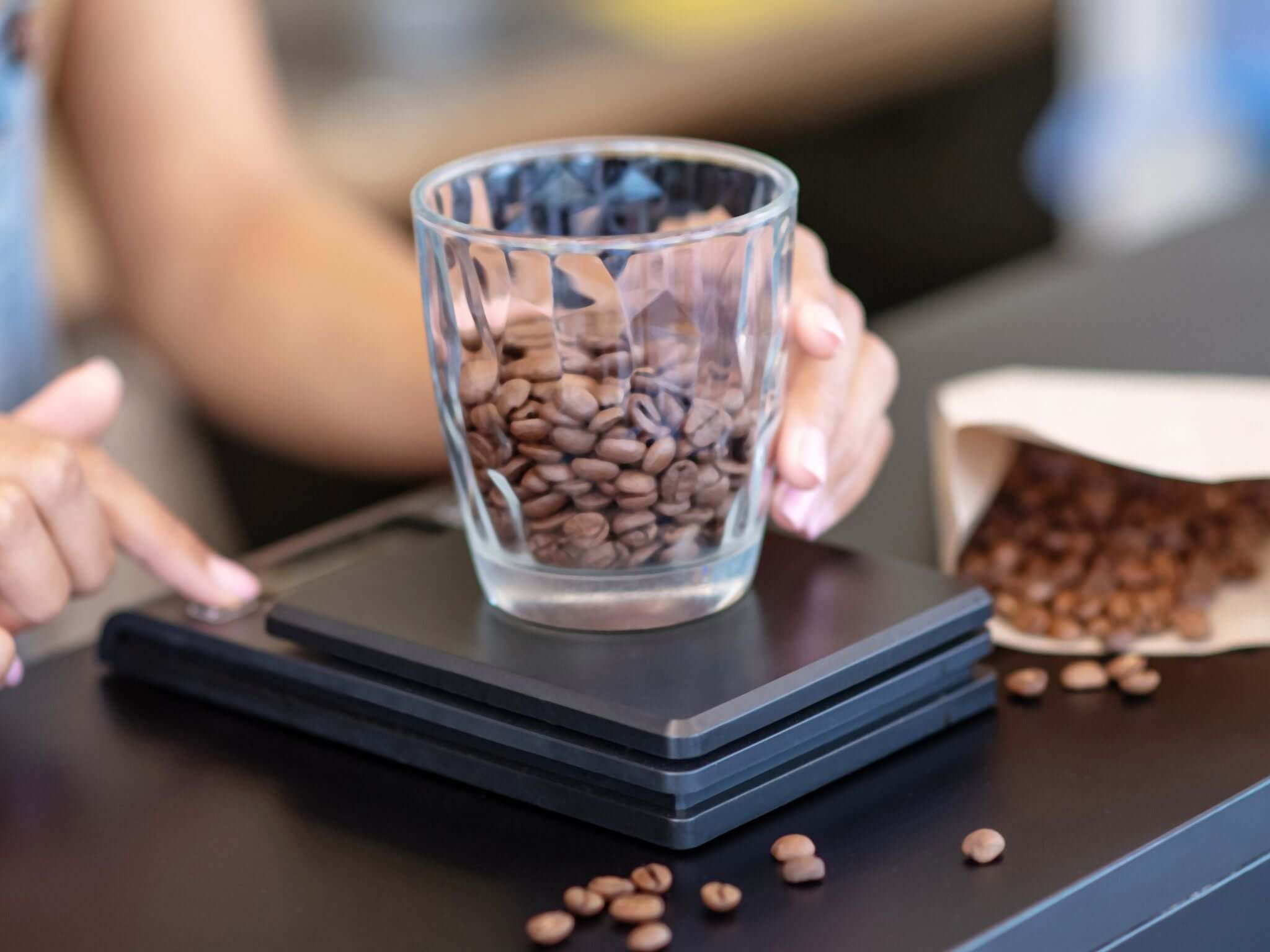 Barista weighing coffee beans for extraction