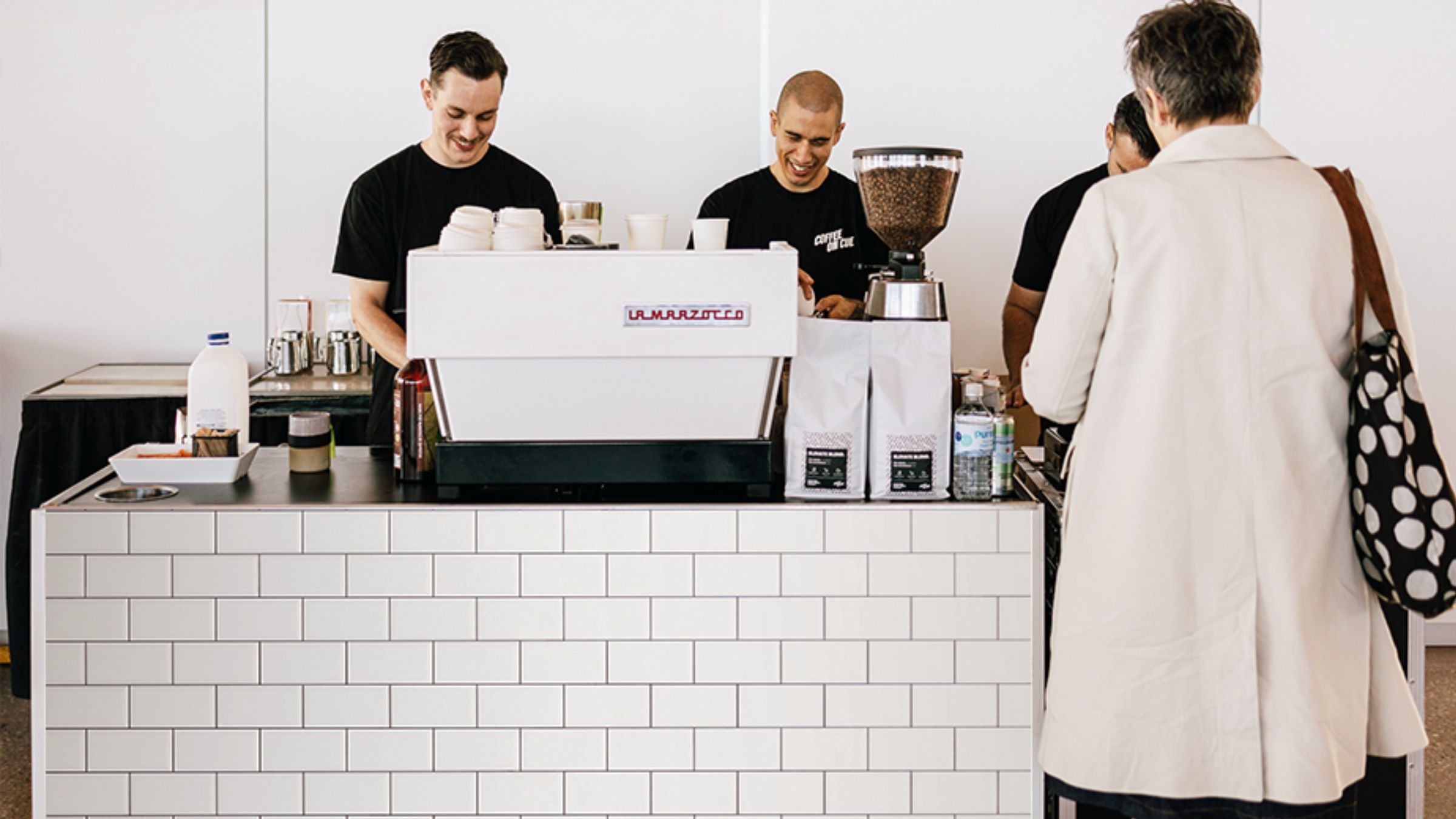 Coffee on Cue baristas serving attendees at Sydney market event