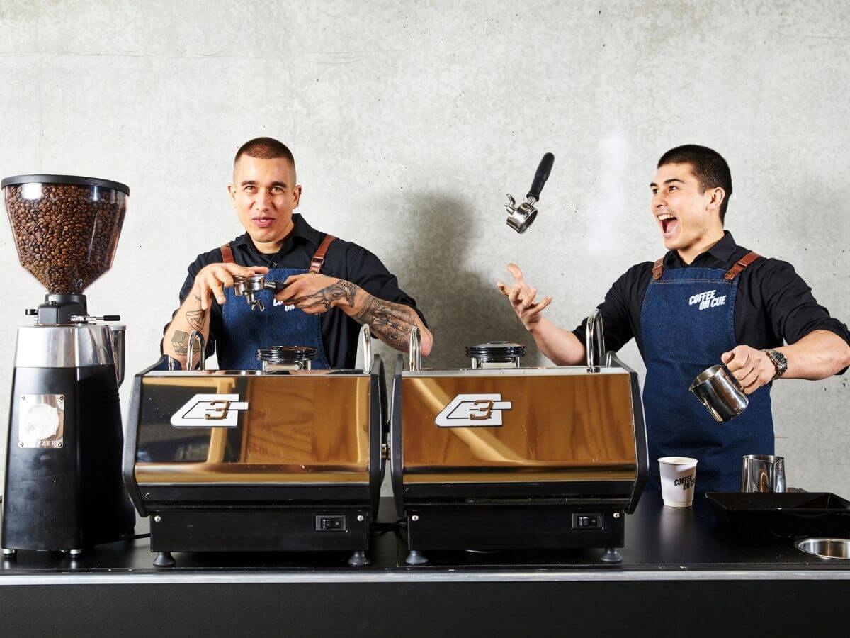 Two baristas operating their coffee cart