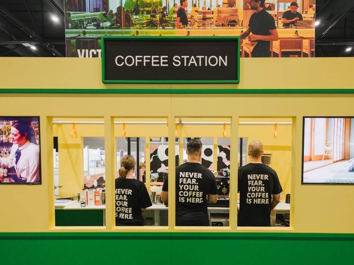 Three baristas inside tram tradestand