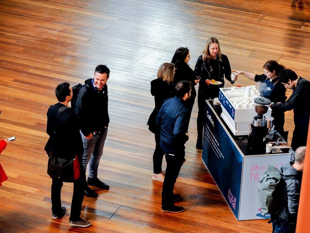 Conference delegates waiting at the coffee cart