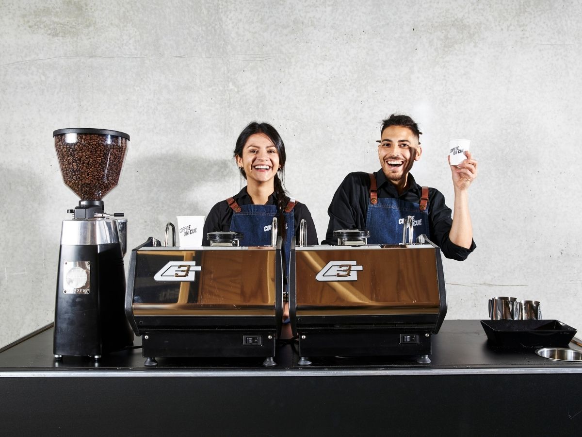 Two baristas and twin gs3 coffee cart