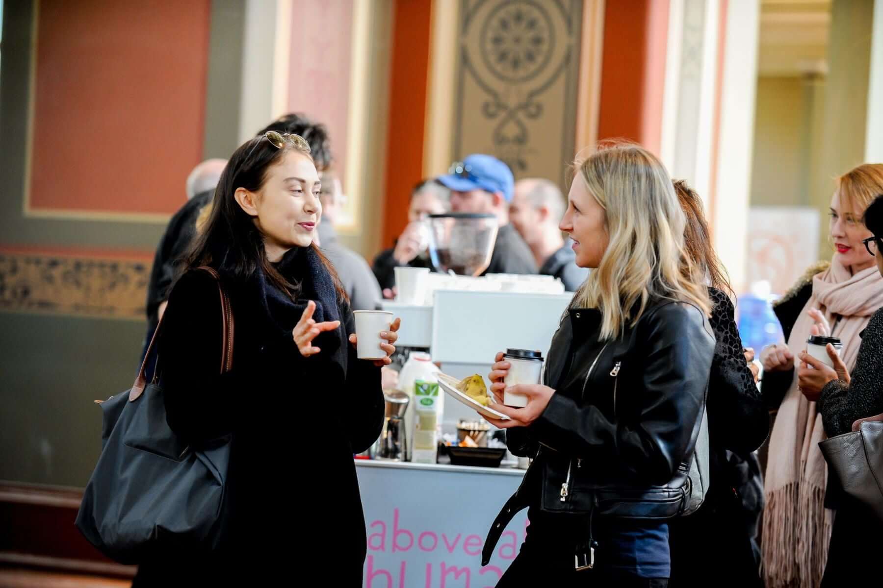 Conference delegates drinking takeaway coffee