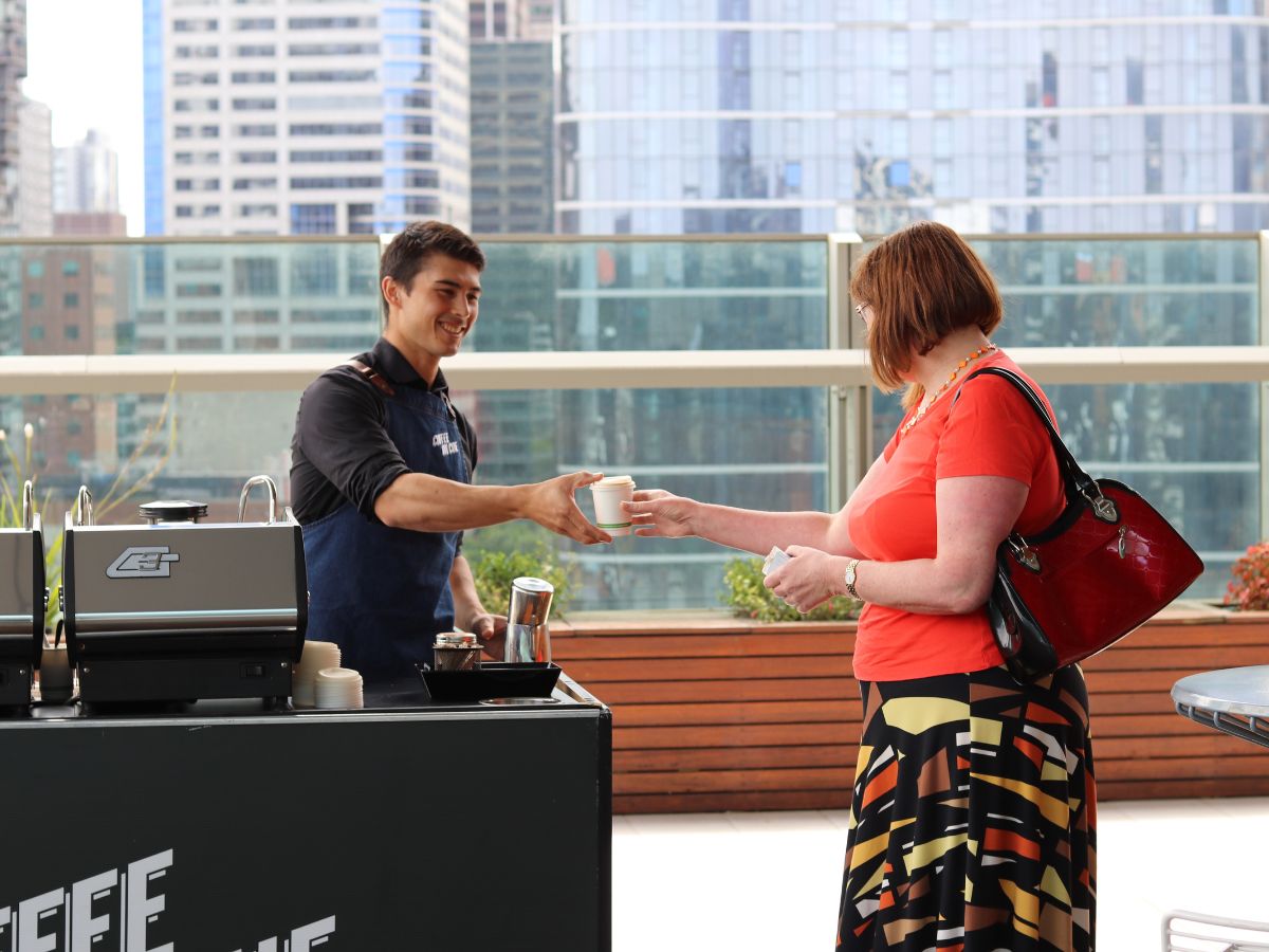 Corporate staff member receiving their coffee at the coffee cart
