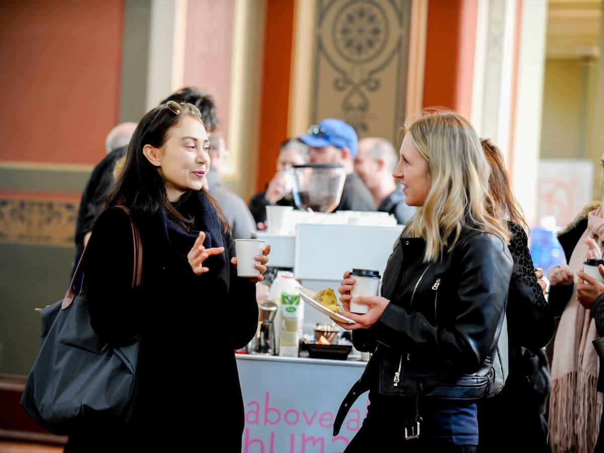 Conference delegates talking and drinking their coffee