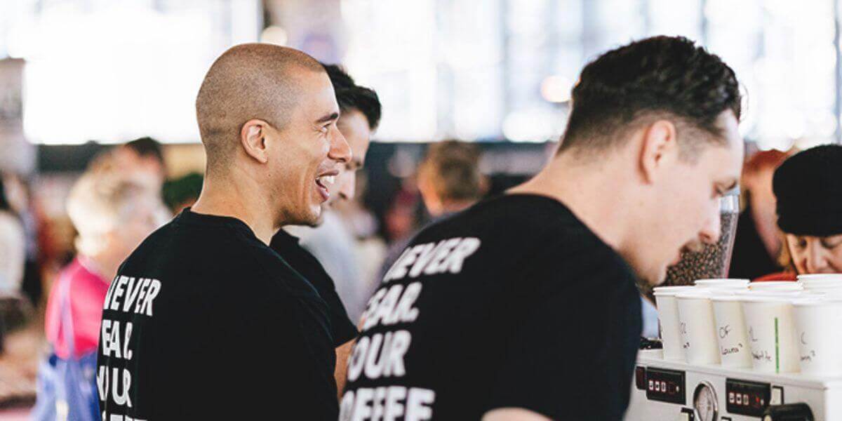 Event baristas serving coffee to guests