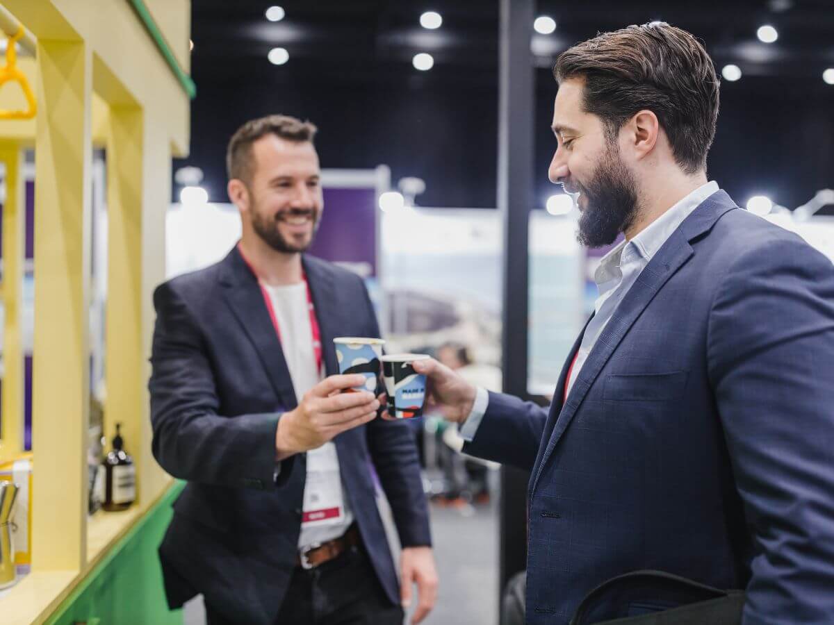 Two delegates cheering their coffees