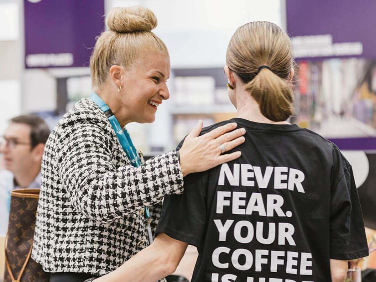 Event guest and Coffee on Cue barista embracing