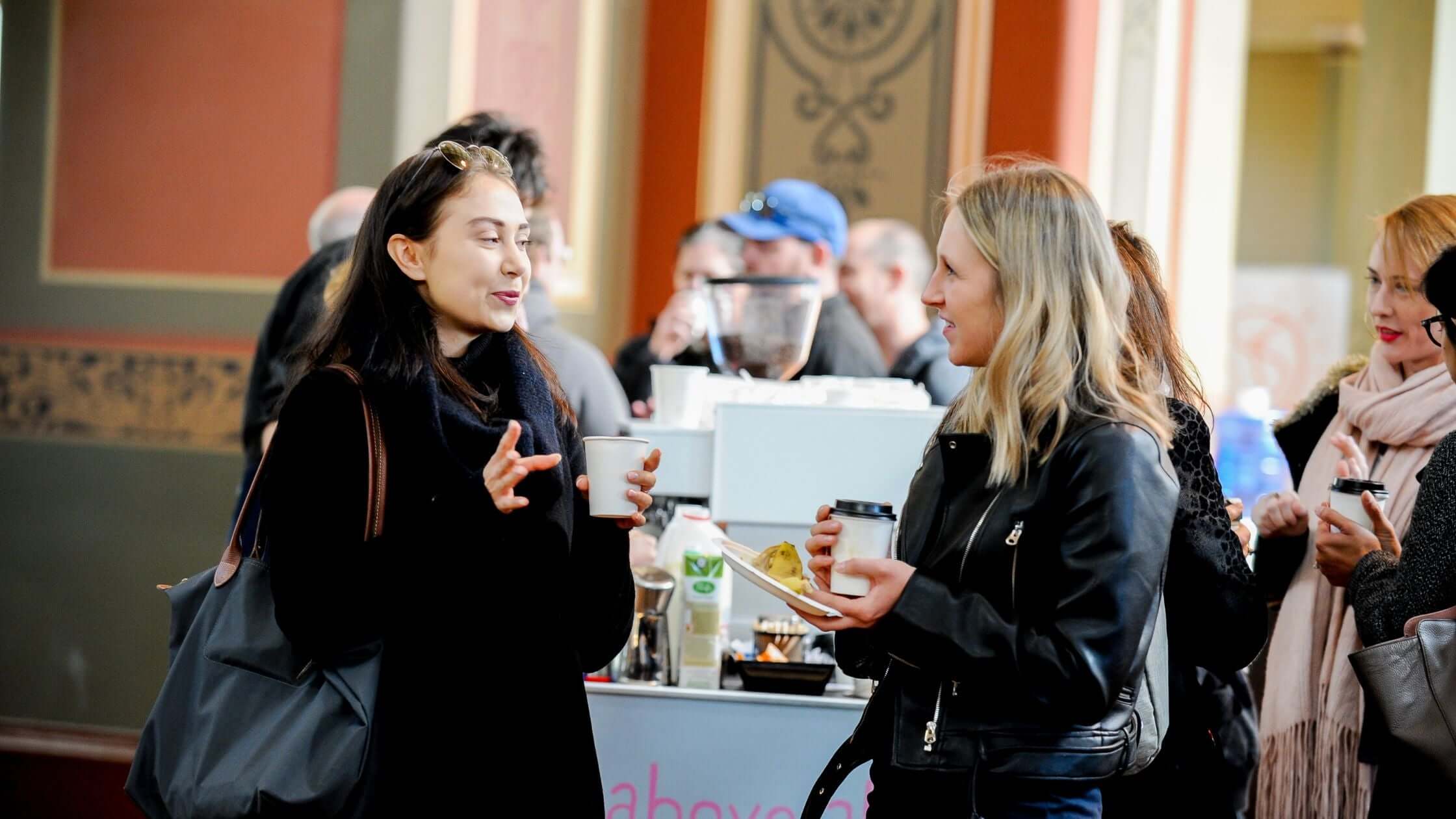 Two conference delegates drinking coffee