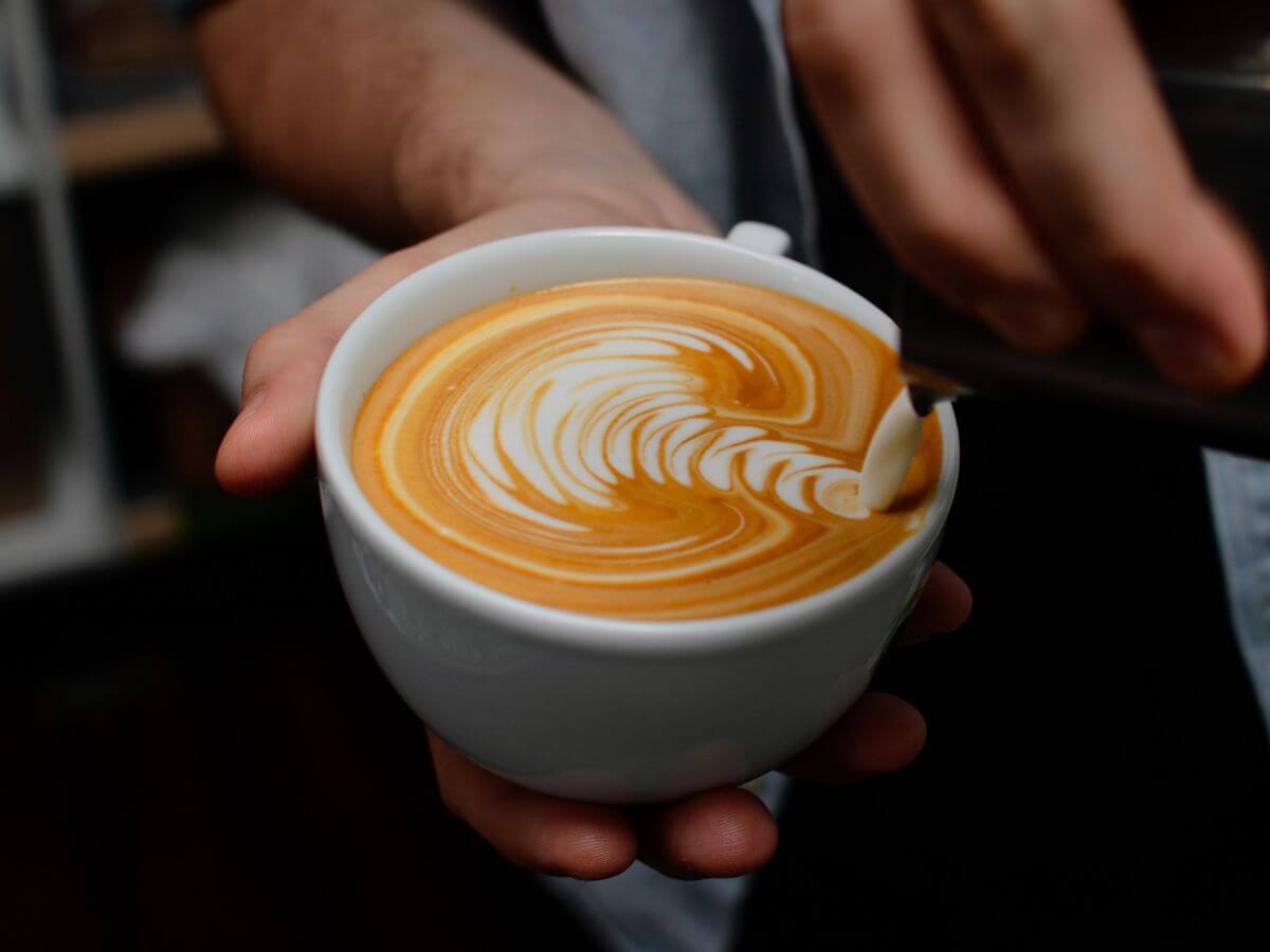 Latte art pour into a flat white