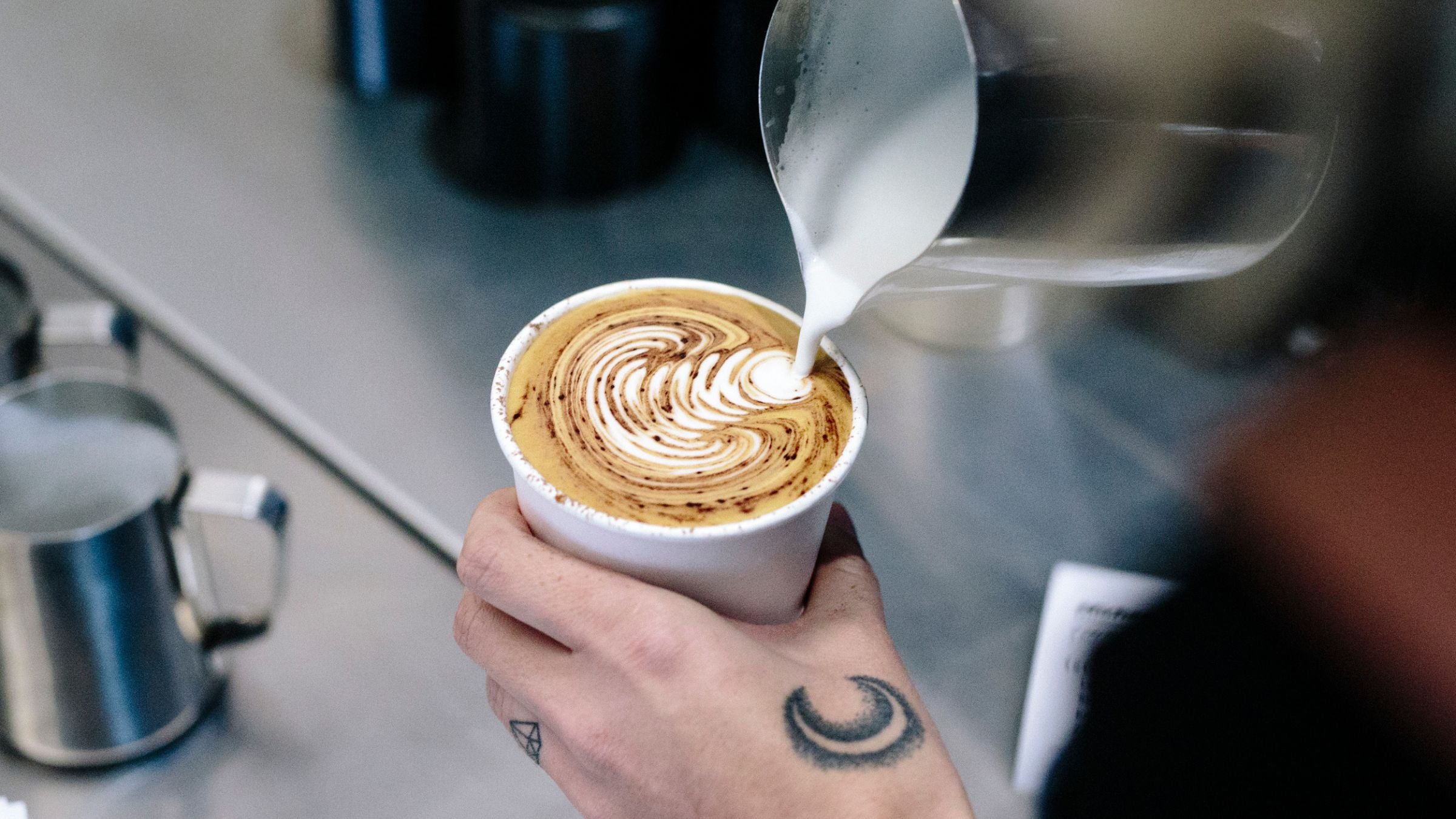 Takeaway coffee with tulip latte art inside