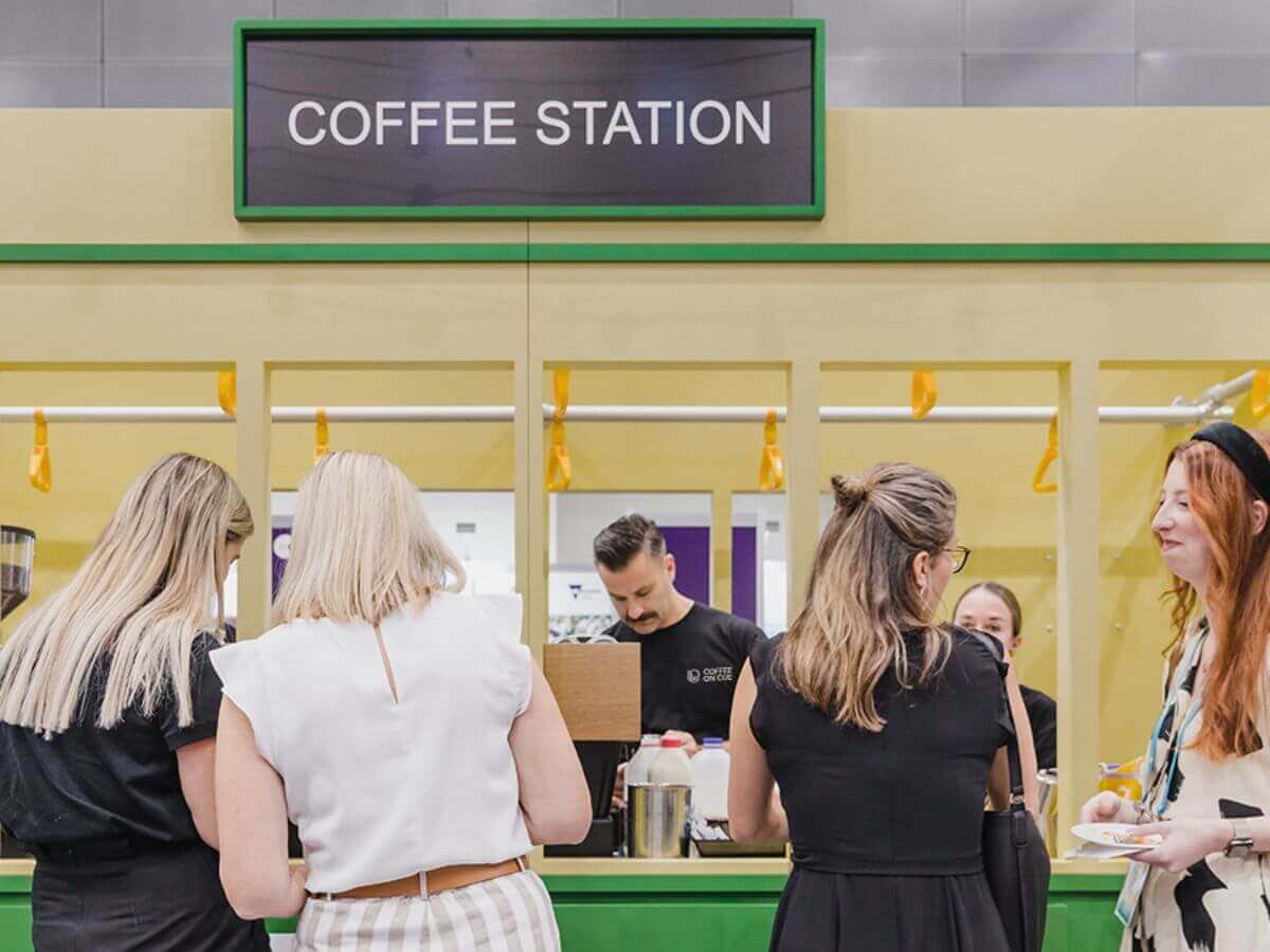 Trade show guests waiting for their coffee from the coffee stand bar