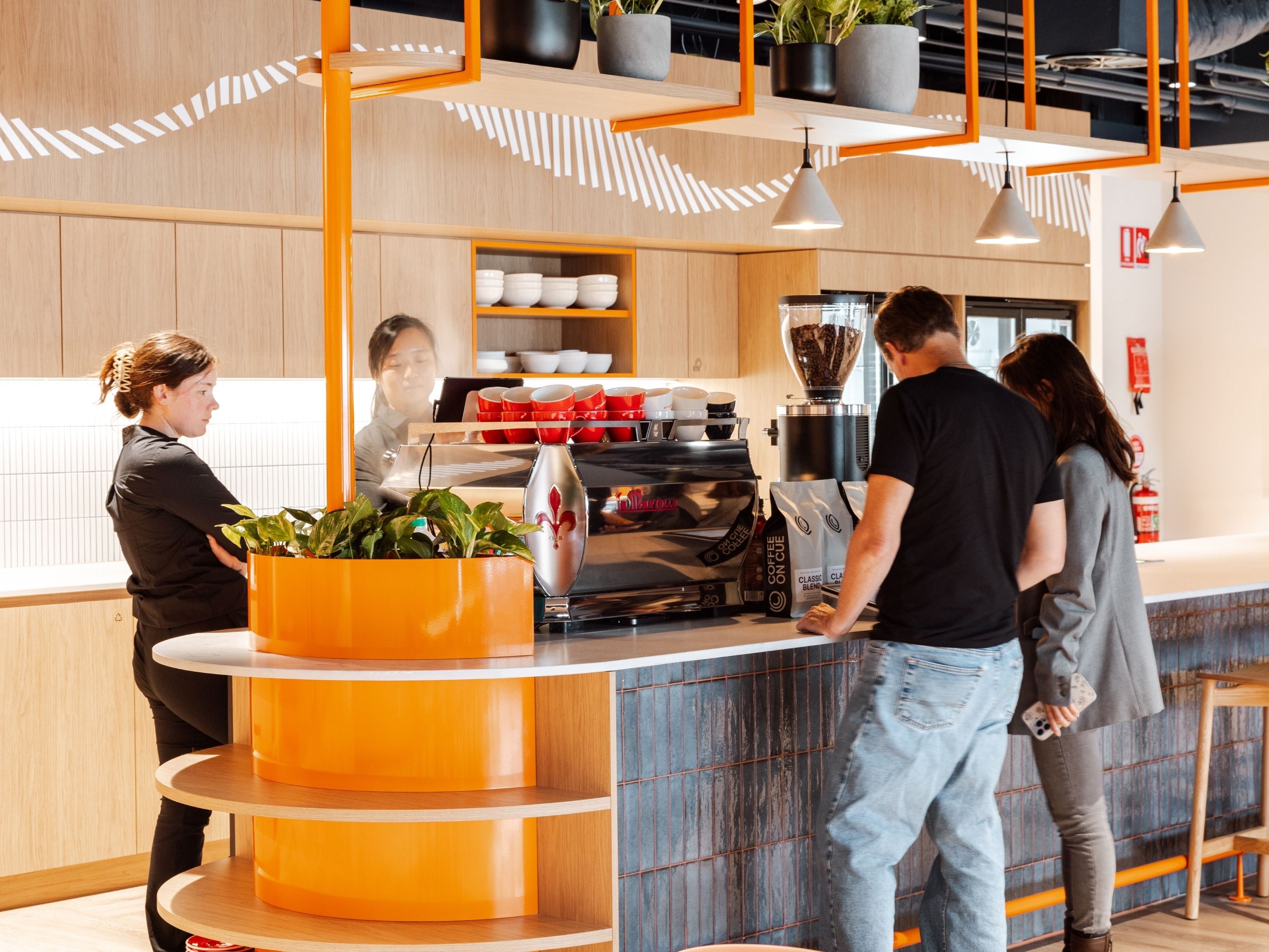 Cuscal barista team serving coffee to office staff