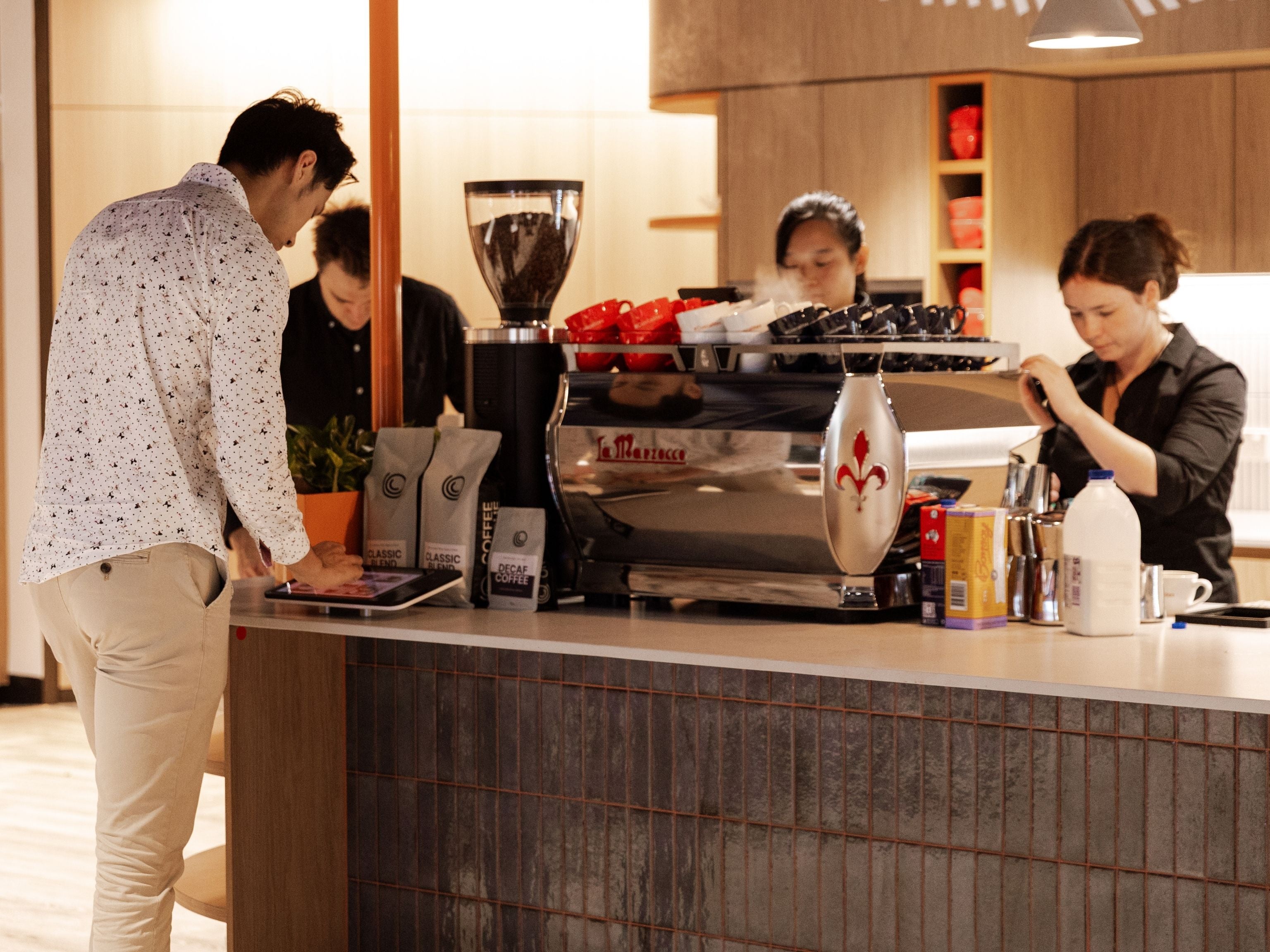 Cuscal employee ordering coffee at their in-house cafe