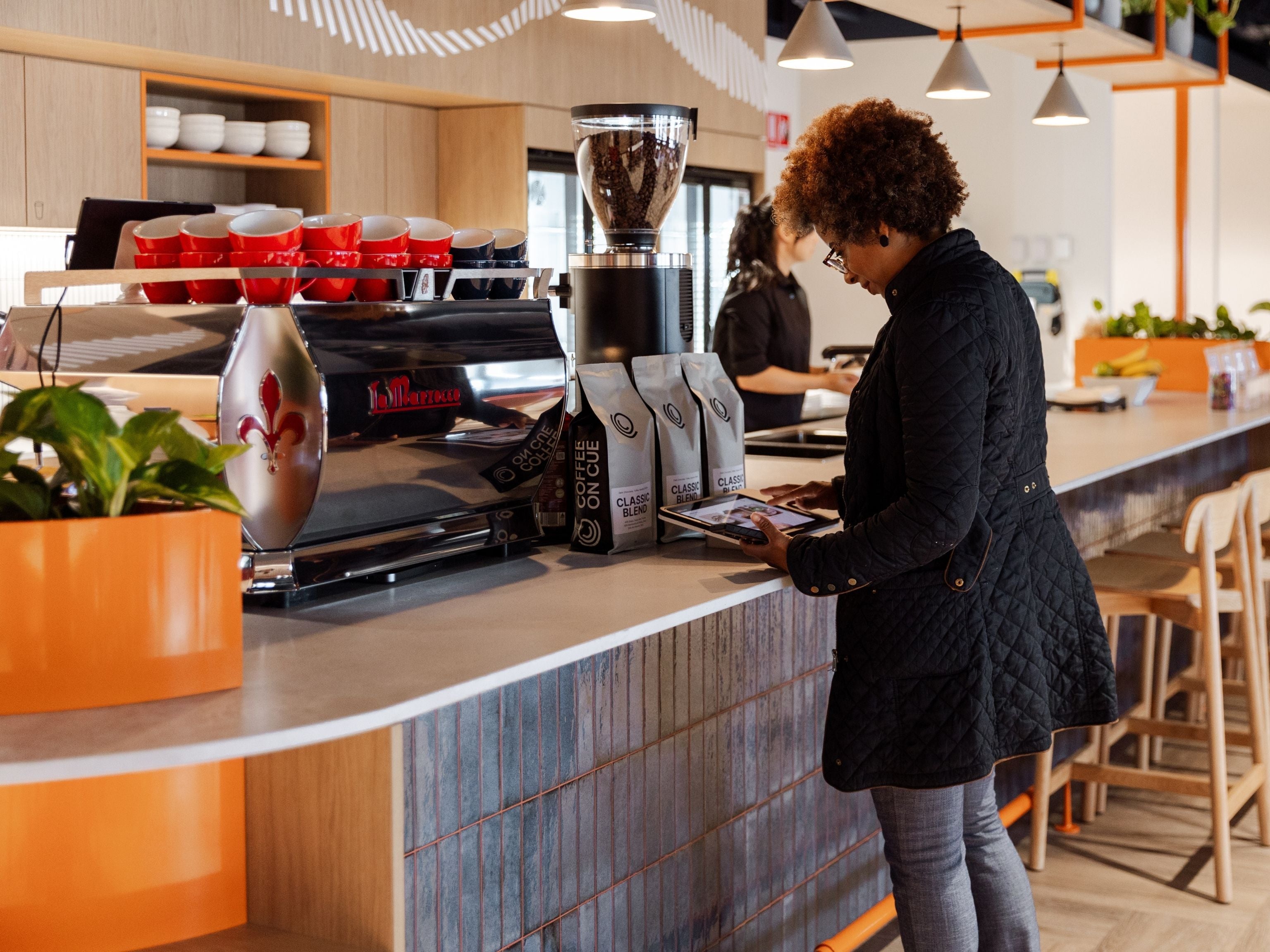 Employee placing their coffee order with square pos system