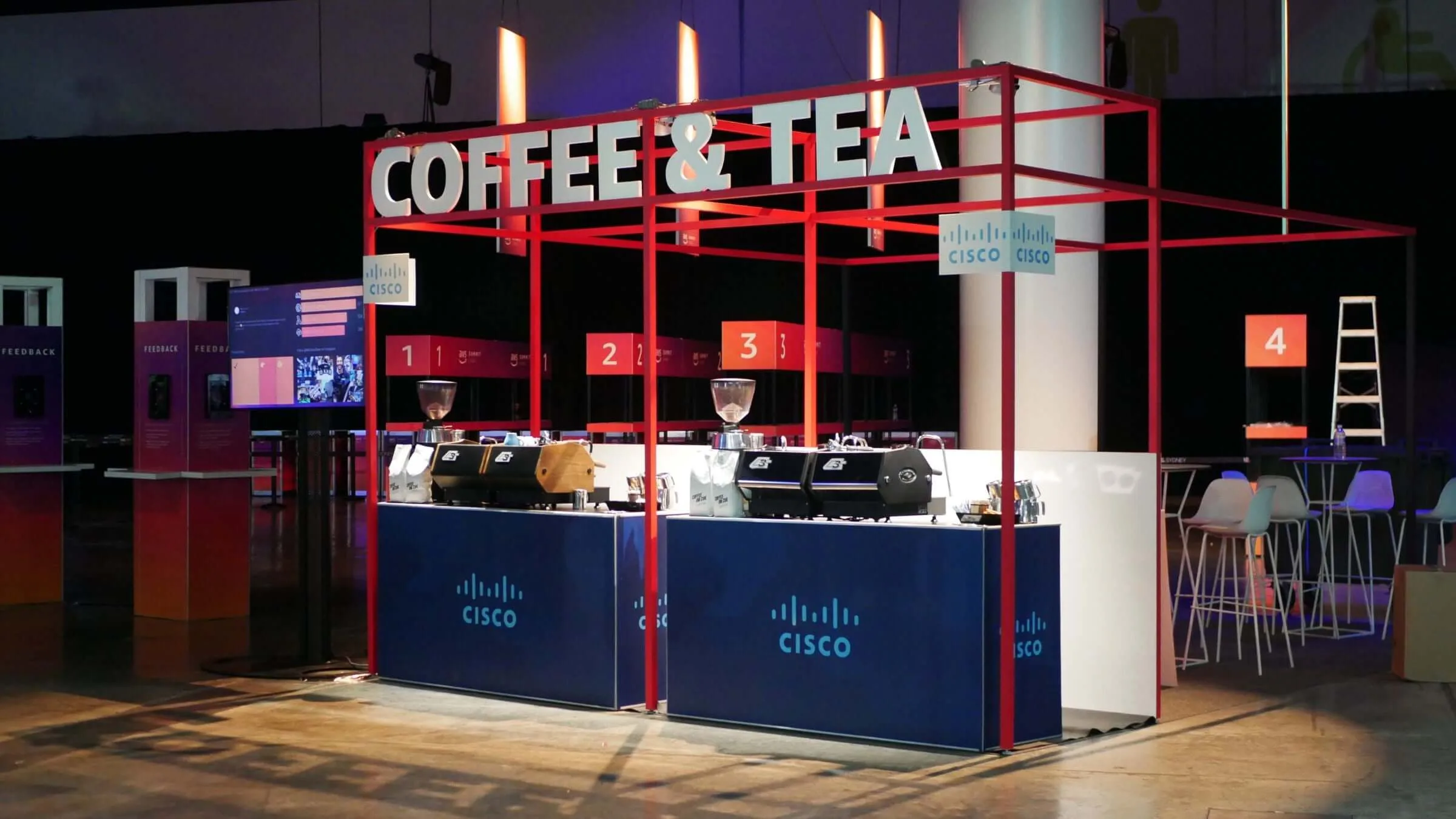 Two branded Coffee on Cue carts side by side, ready to serve a conference foyer