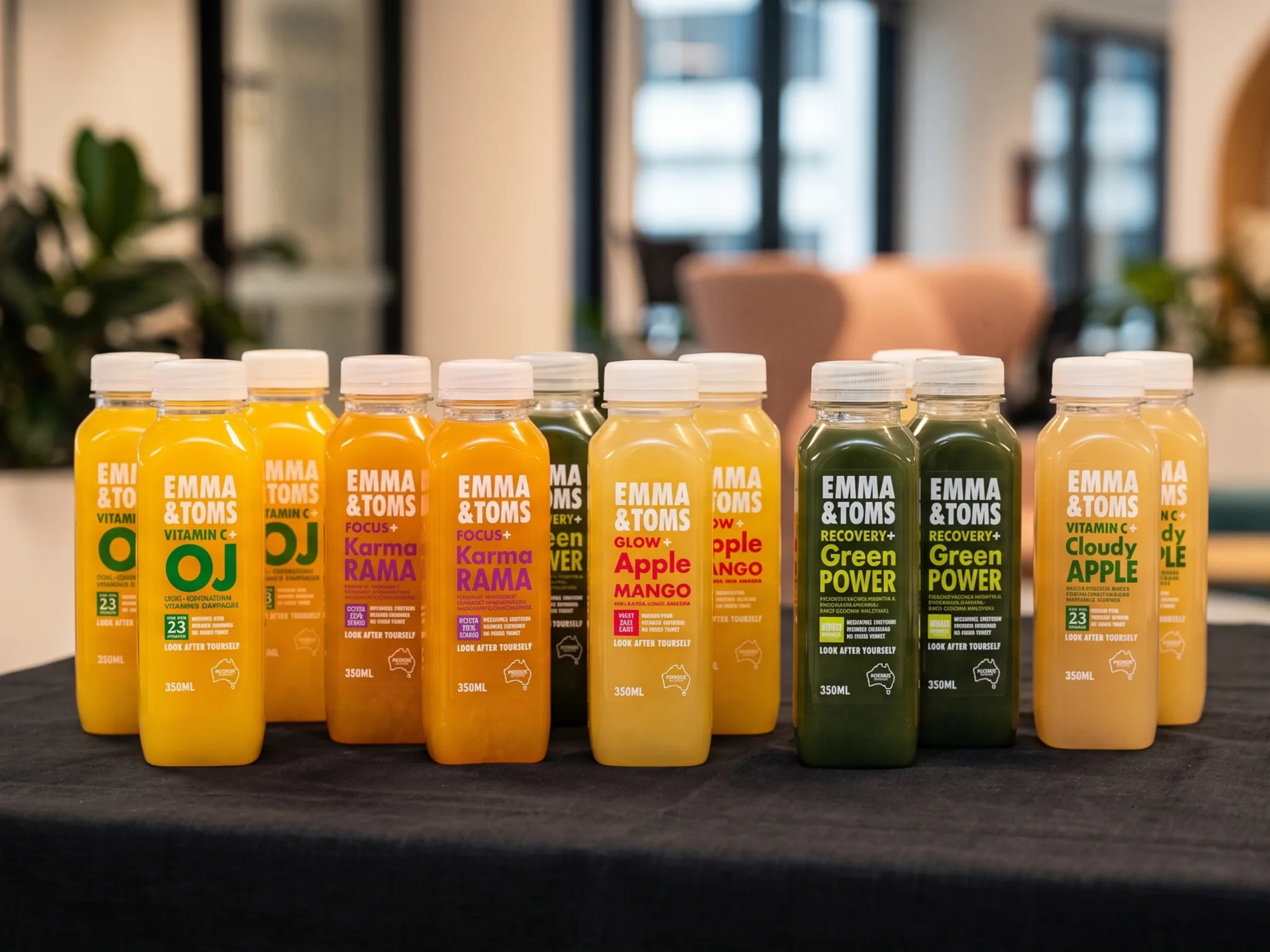 A lineup of chilled fresh juice bottles set out on a table