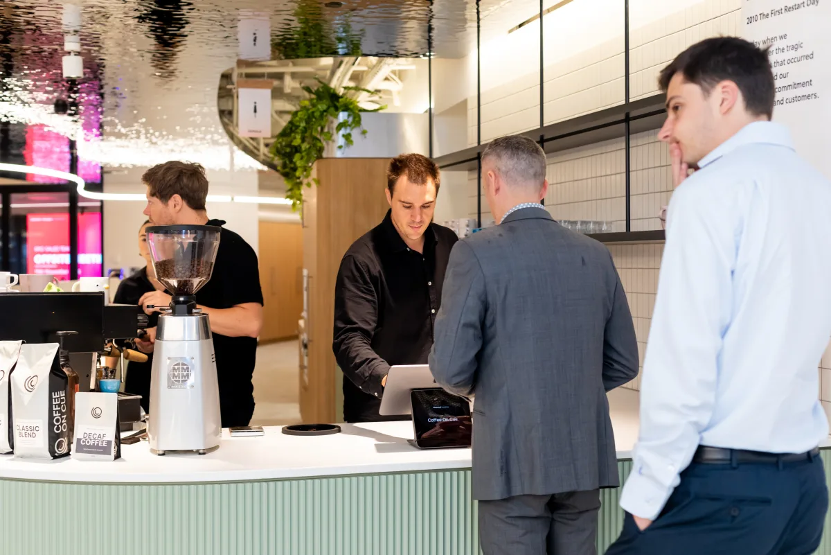 A barista serving across the counter at the Toyota Financial Services bar