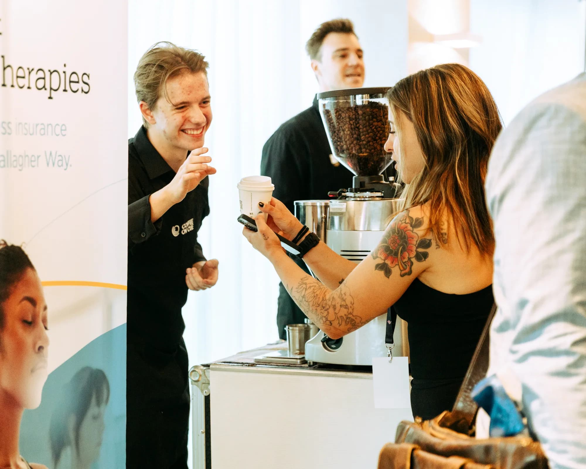 A happy hand-off moment at a workplace coffee bar