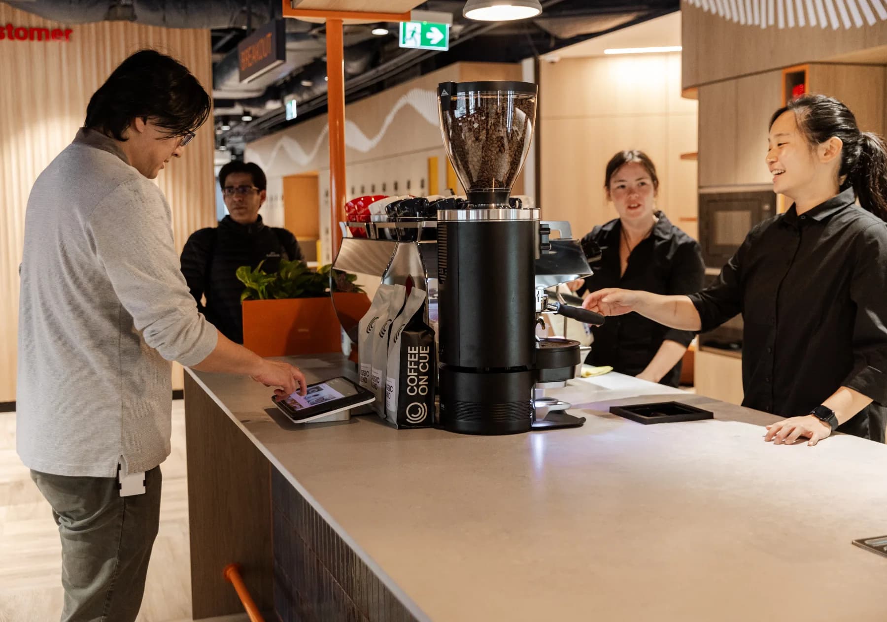 Coffee on Cue baristas serving staff at the in-house barista bar at Cuscal
