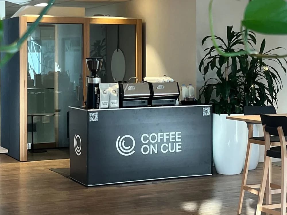 A self-contained Coffee on Cue cart set up in an office lobby, ready to serve