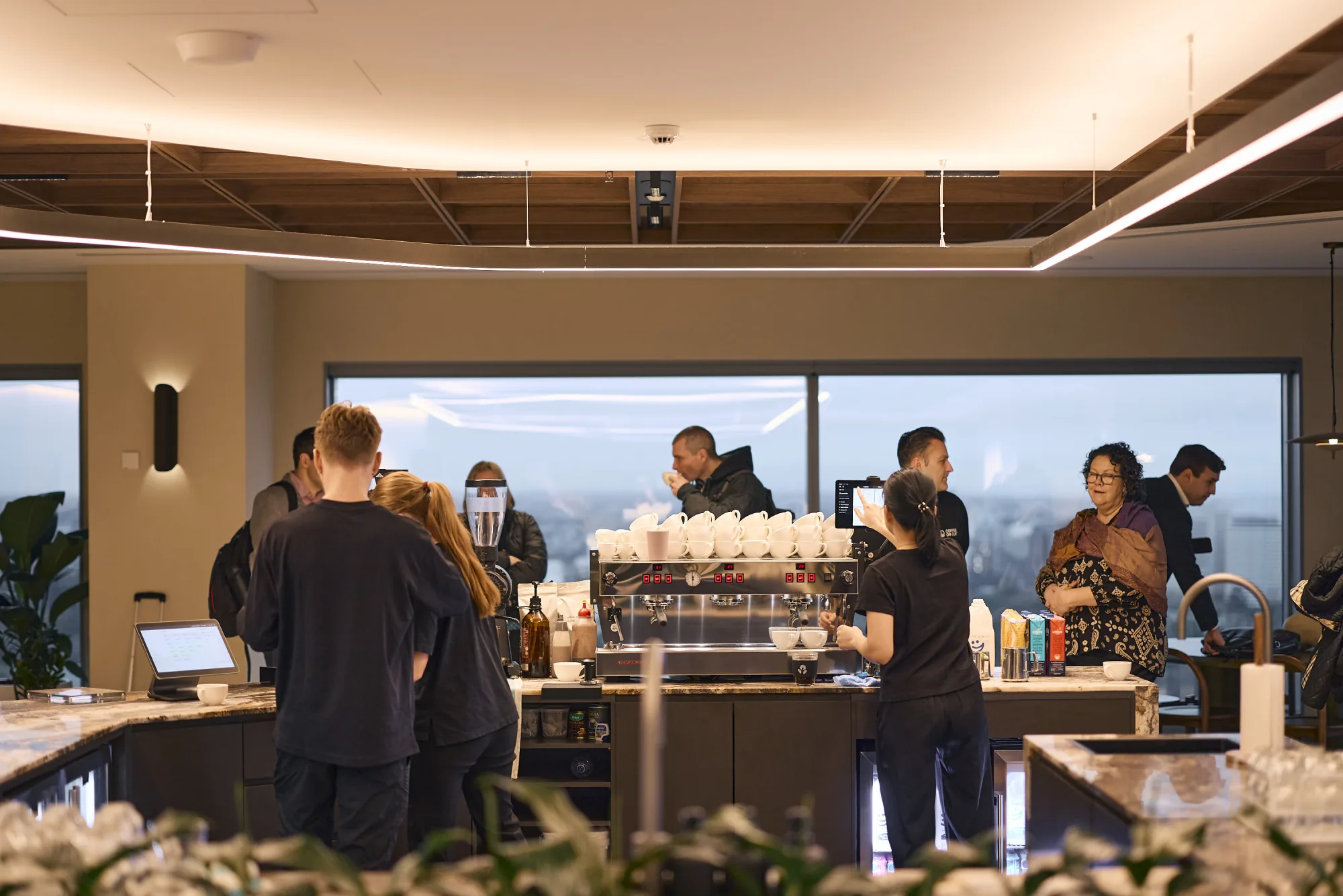 The busy in-house bar at JLL 101 Collins, the crew serving through the morning