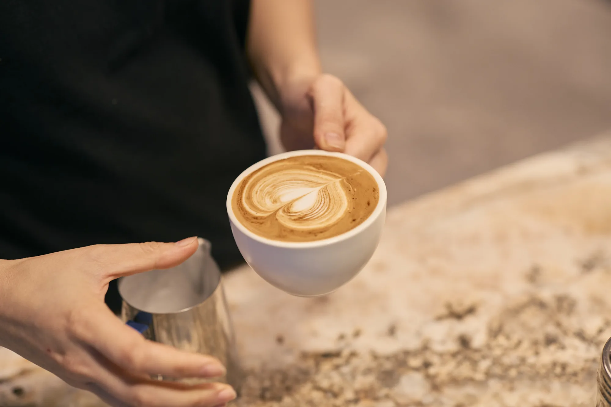 A finished rosetta handed across the marble counter at JLL 101 Collins