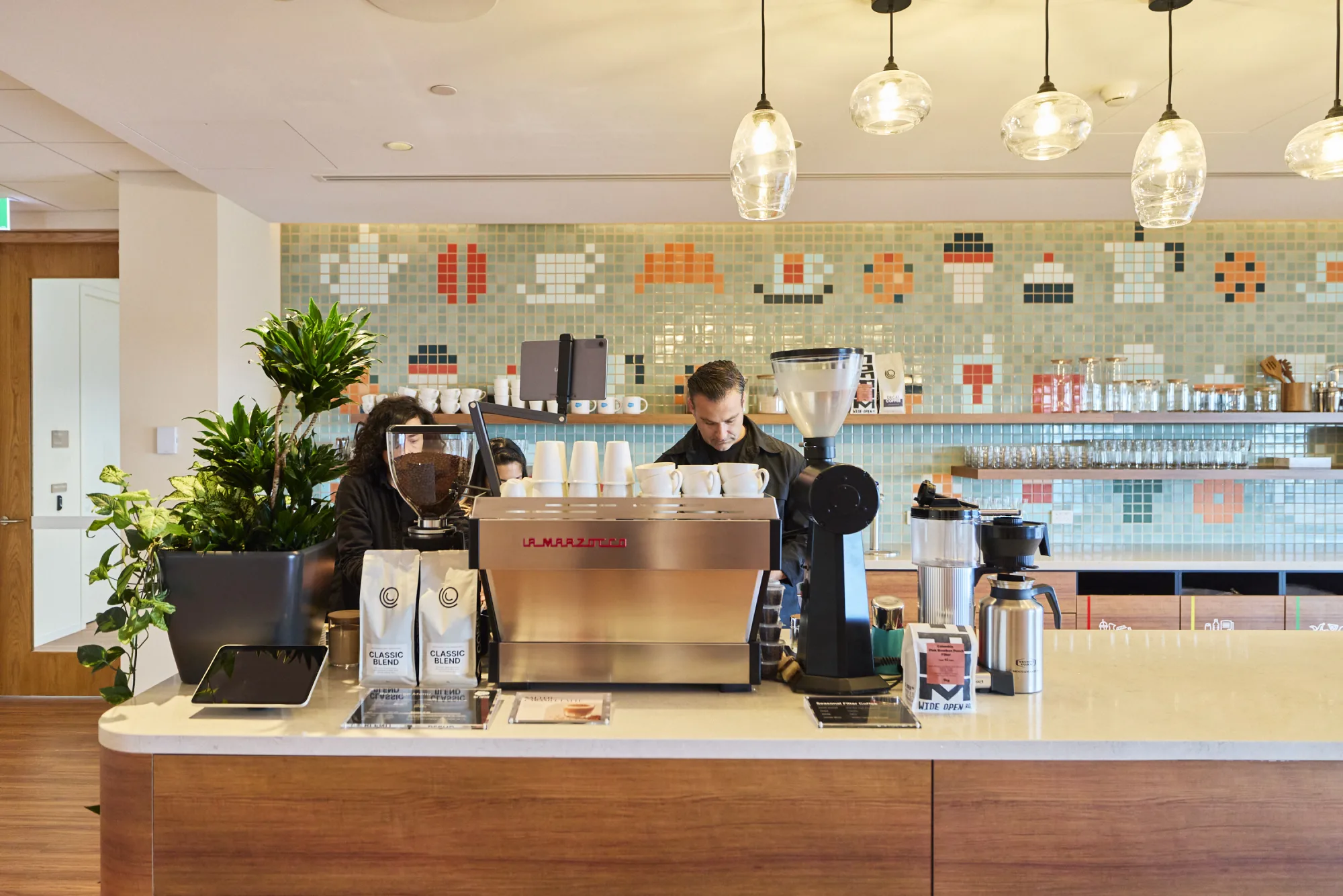 A Coffee on Cue barista running the in-house bar at Salesforce Melbourne