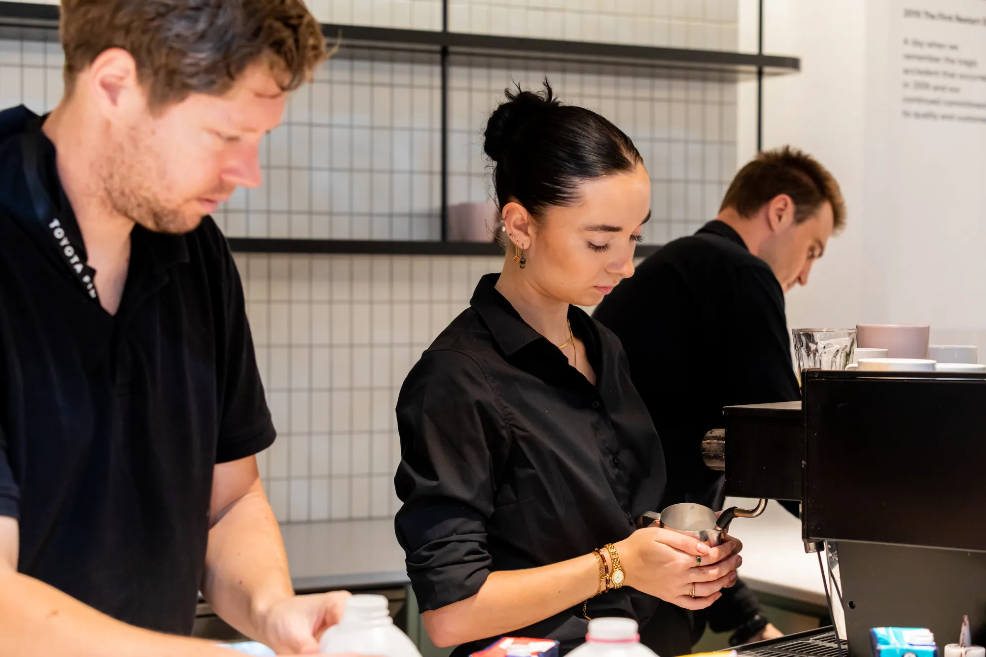 Two Coffee on Cue baristas working the machine at Toyota Financial Services