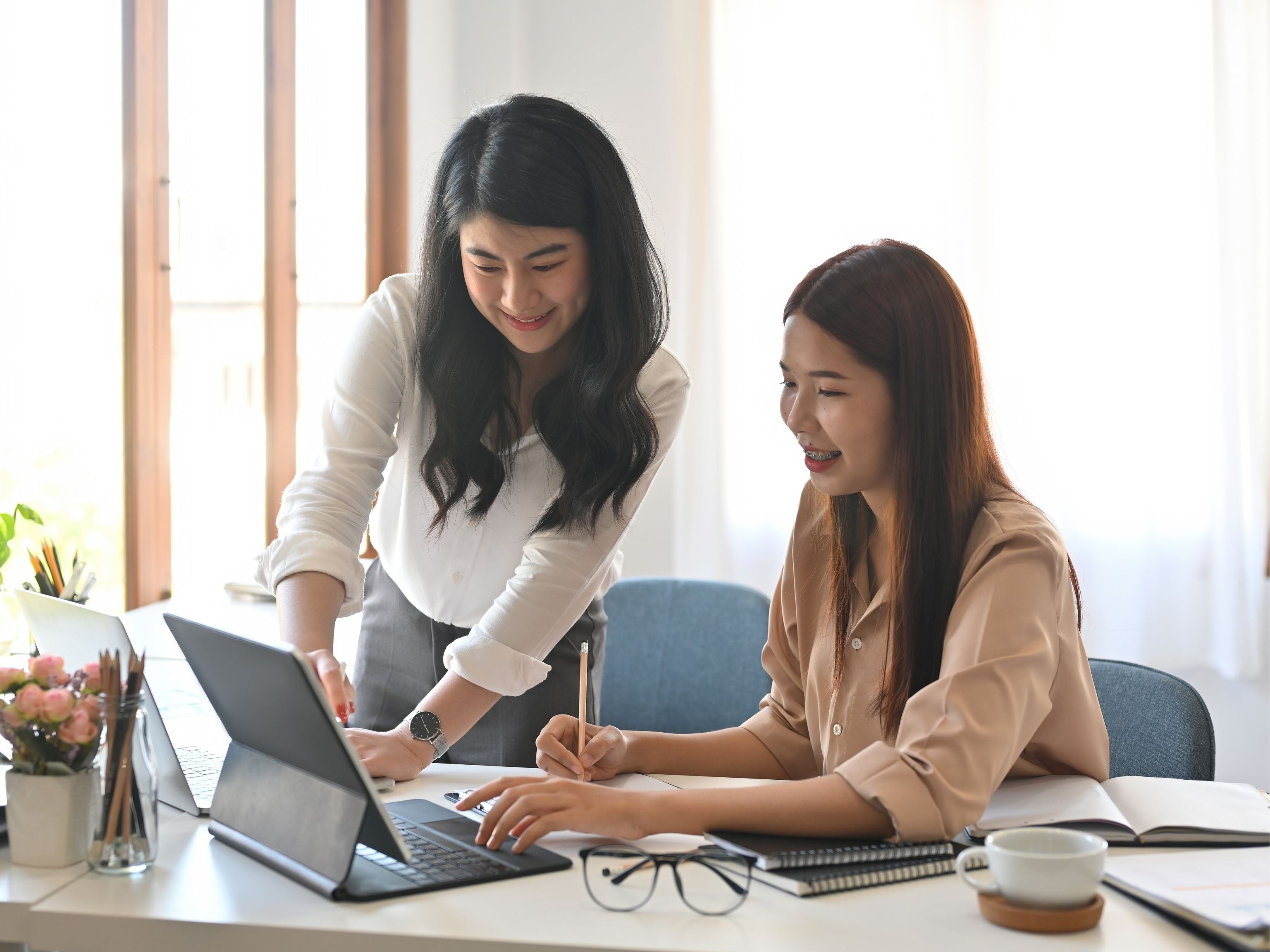 Employees working together on a laptop