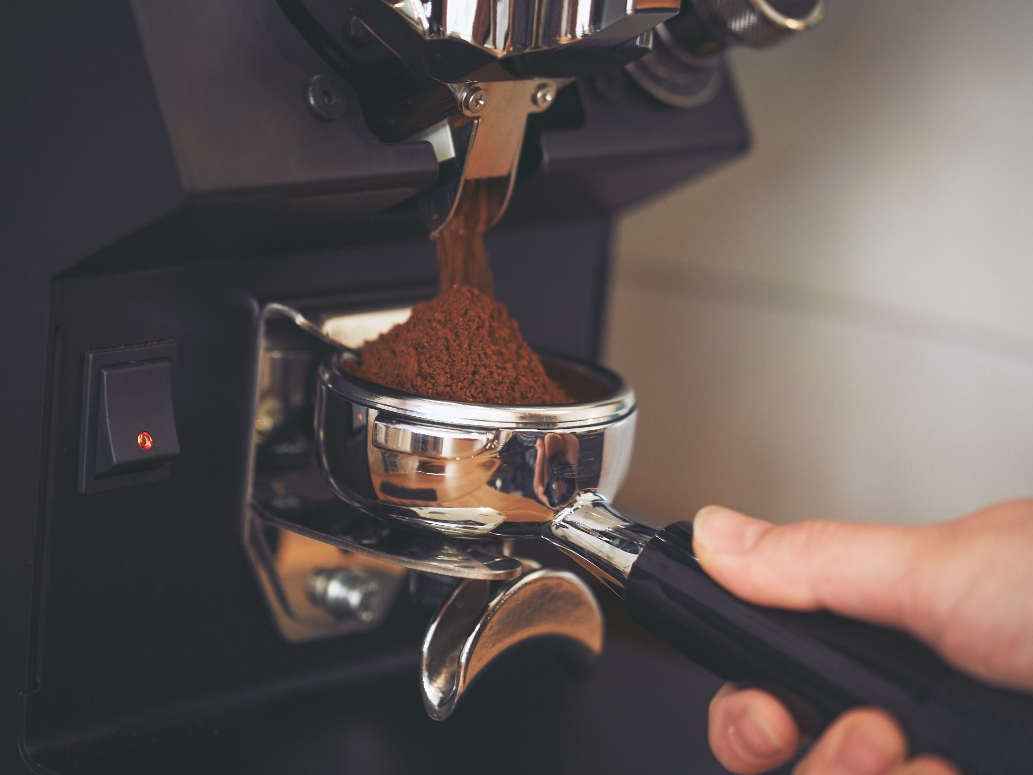 Grinding coffee into portafilter basket