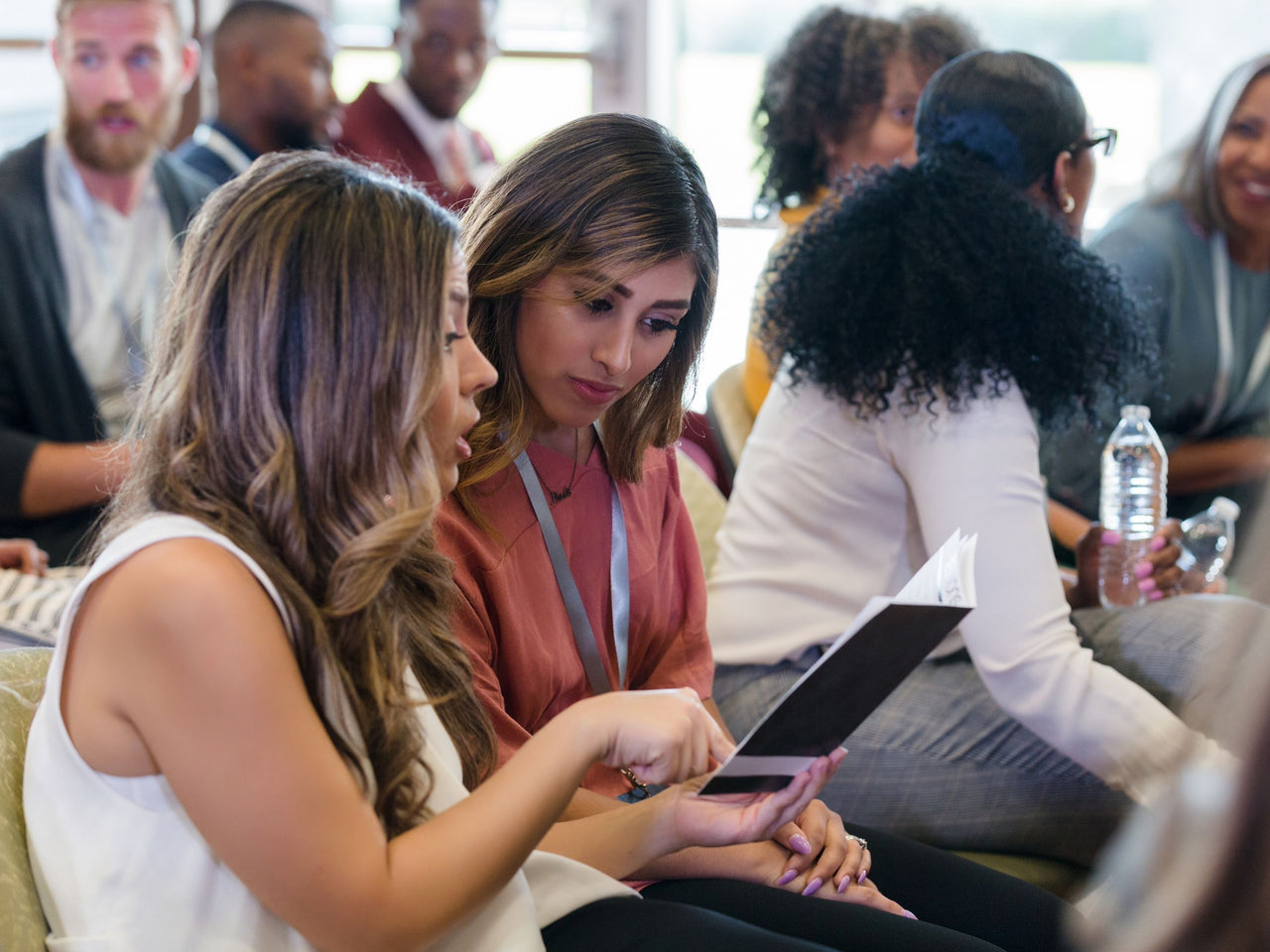 Event guests look through event material