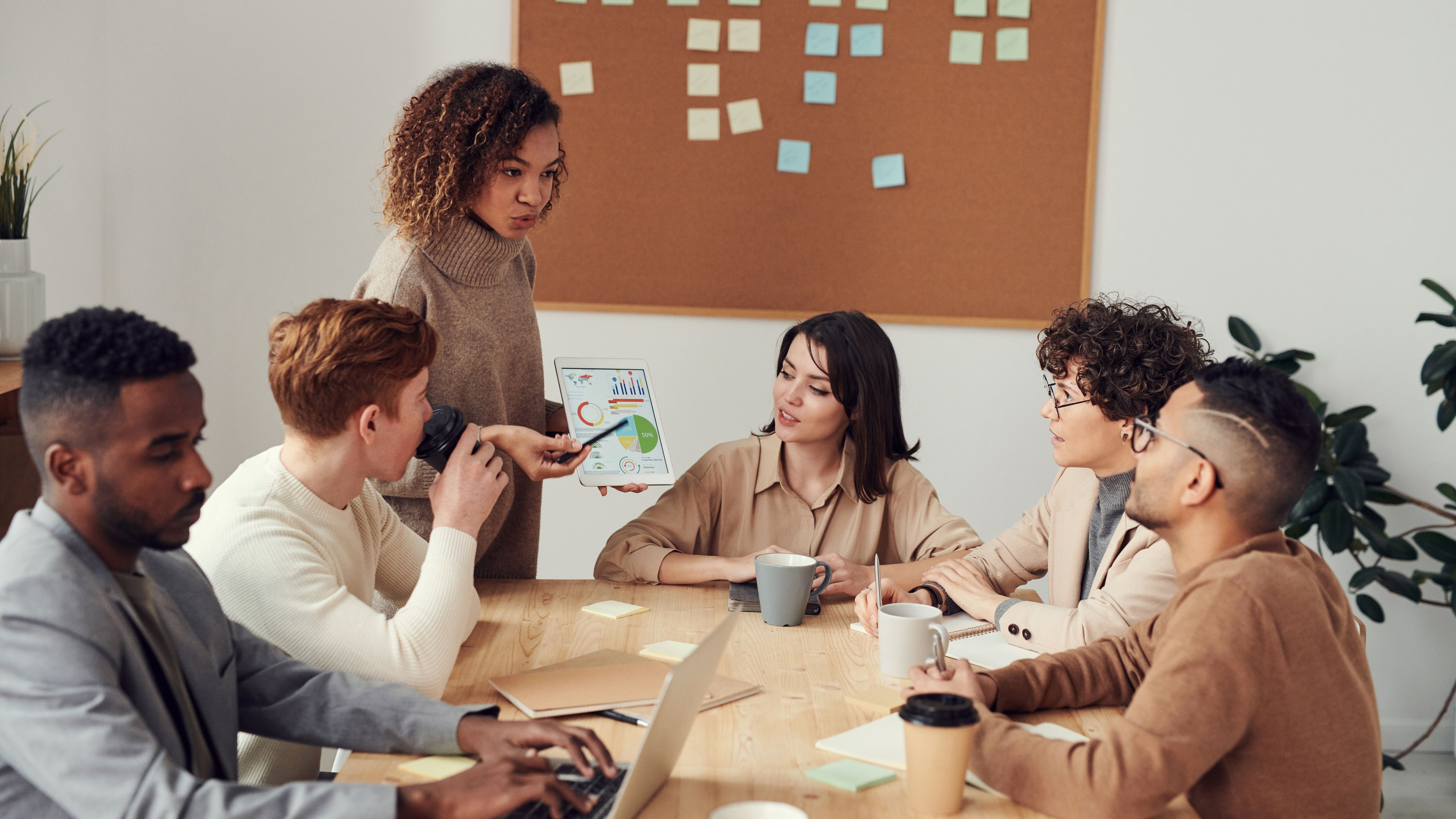 Employees drinking coffee together in their office