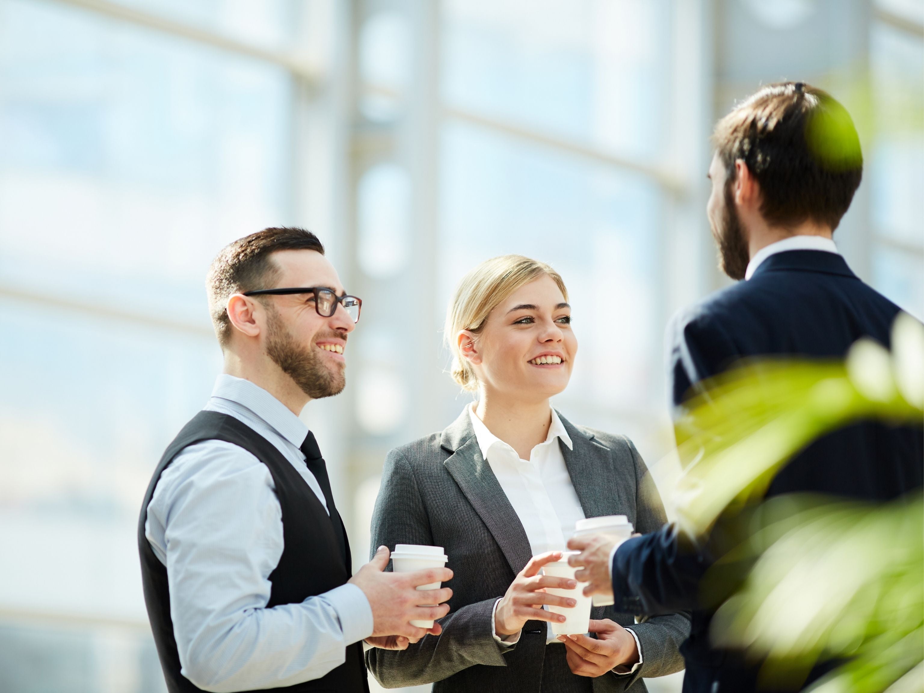 Staff mingling with coffee in hand