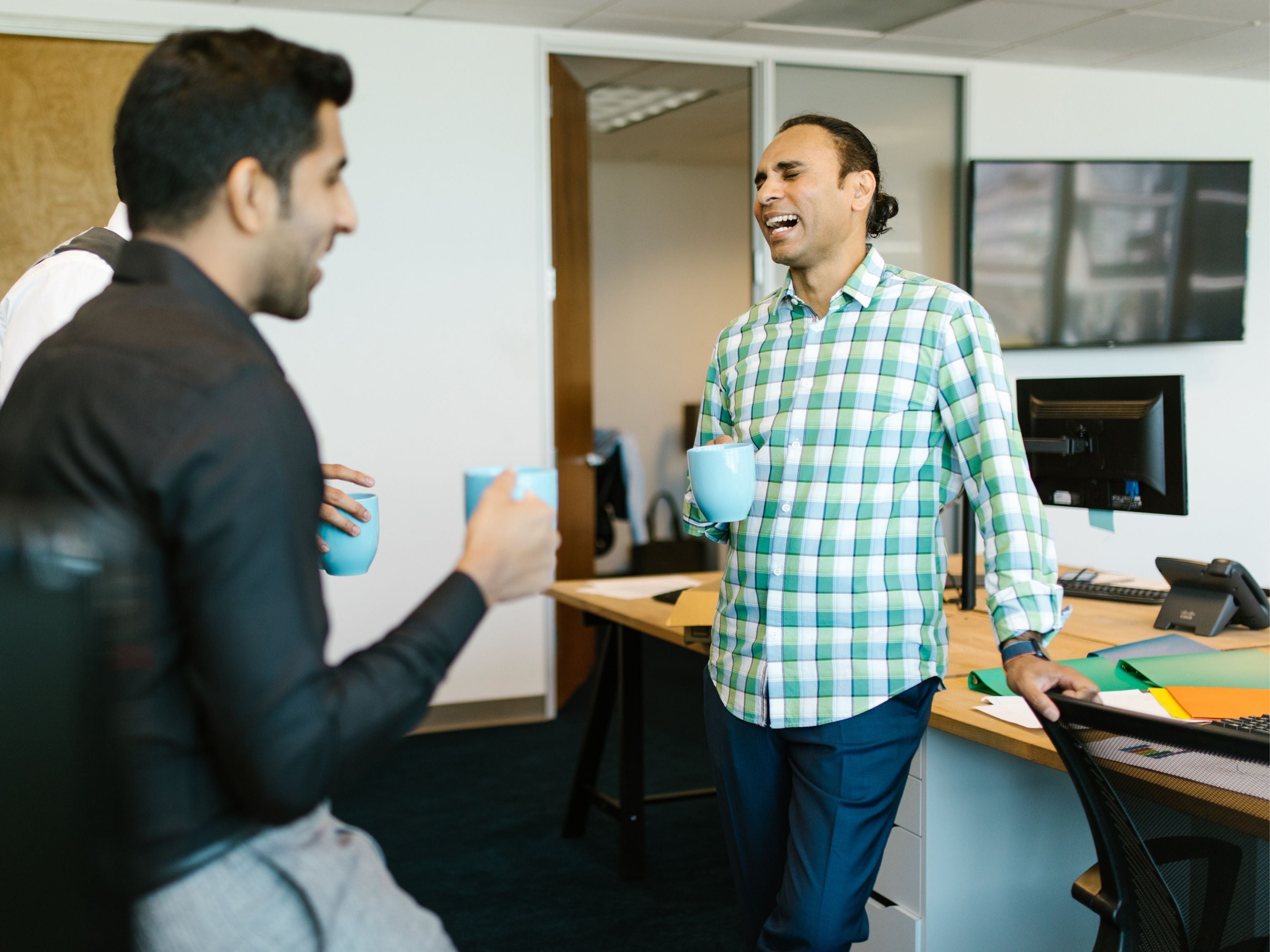 Team drinking coffee at their desks