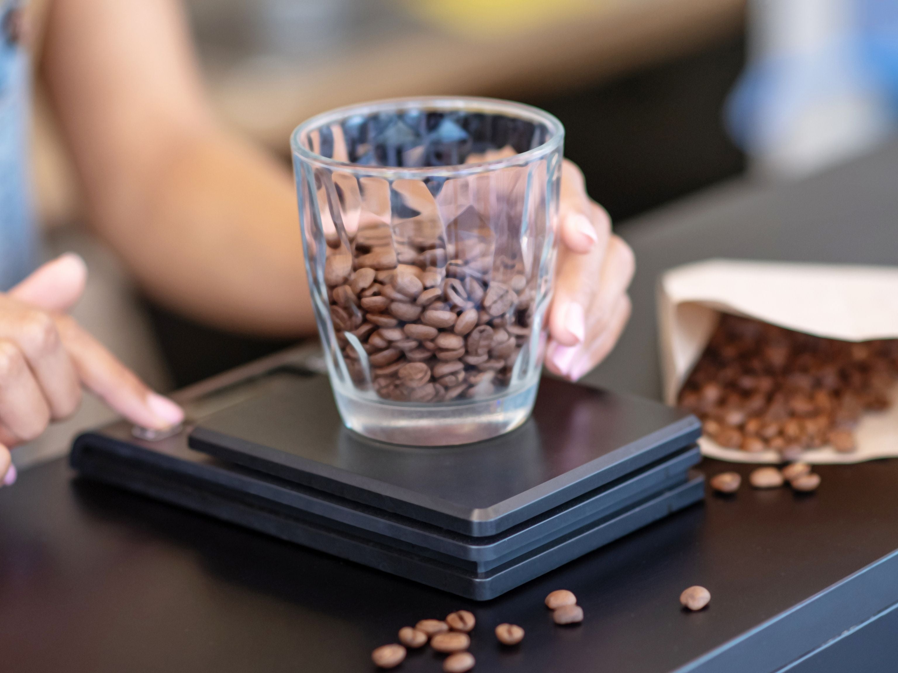 Barista weighing coffee beans for extraction