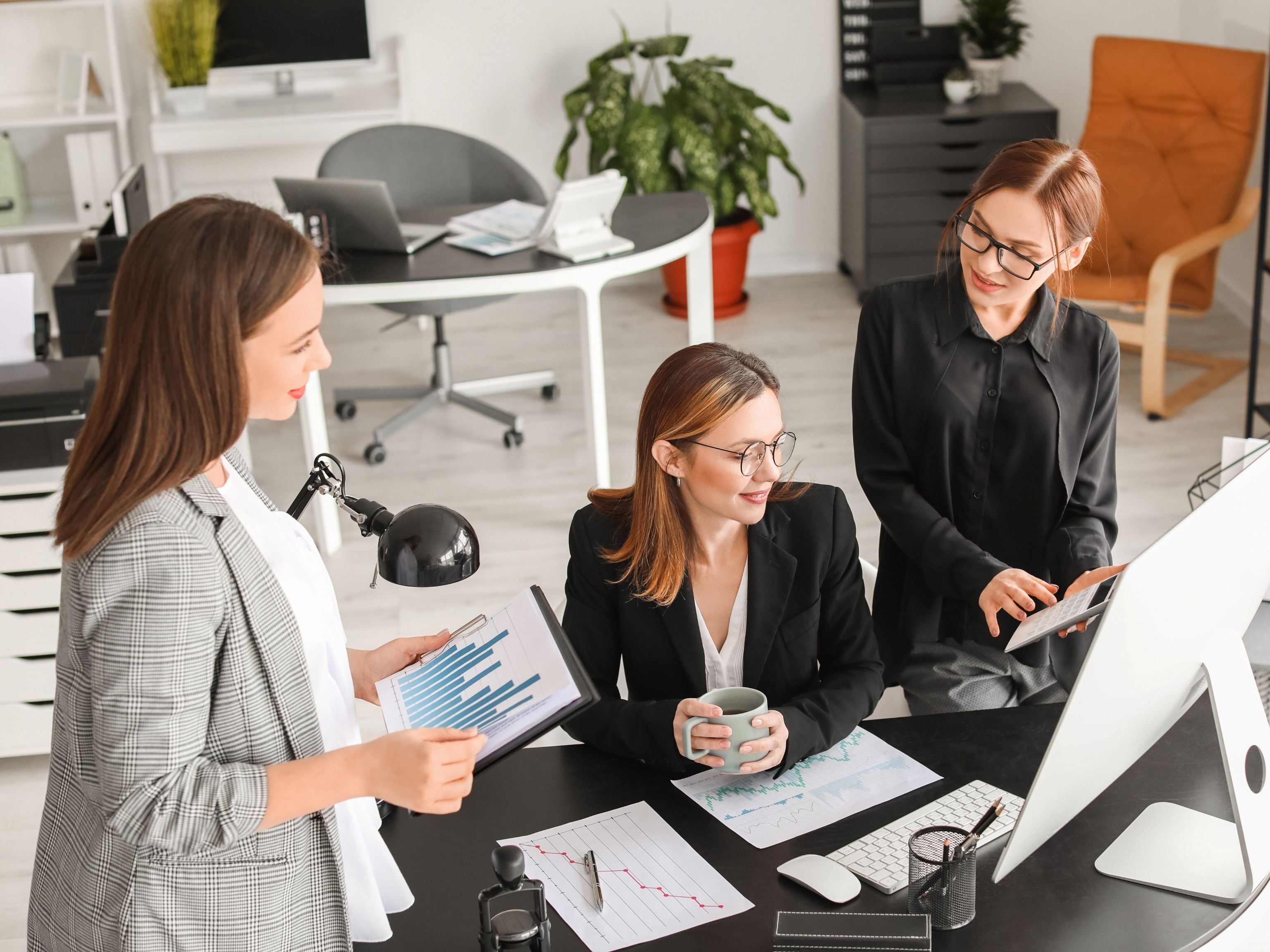 Women drinking coffee at their desk