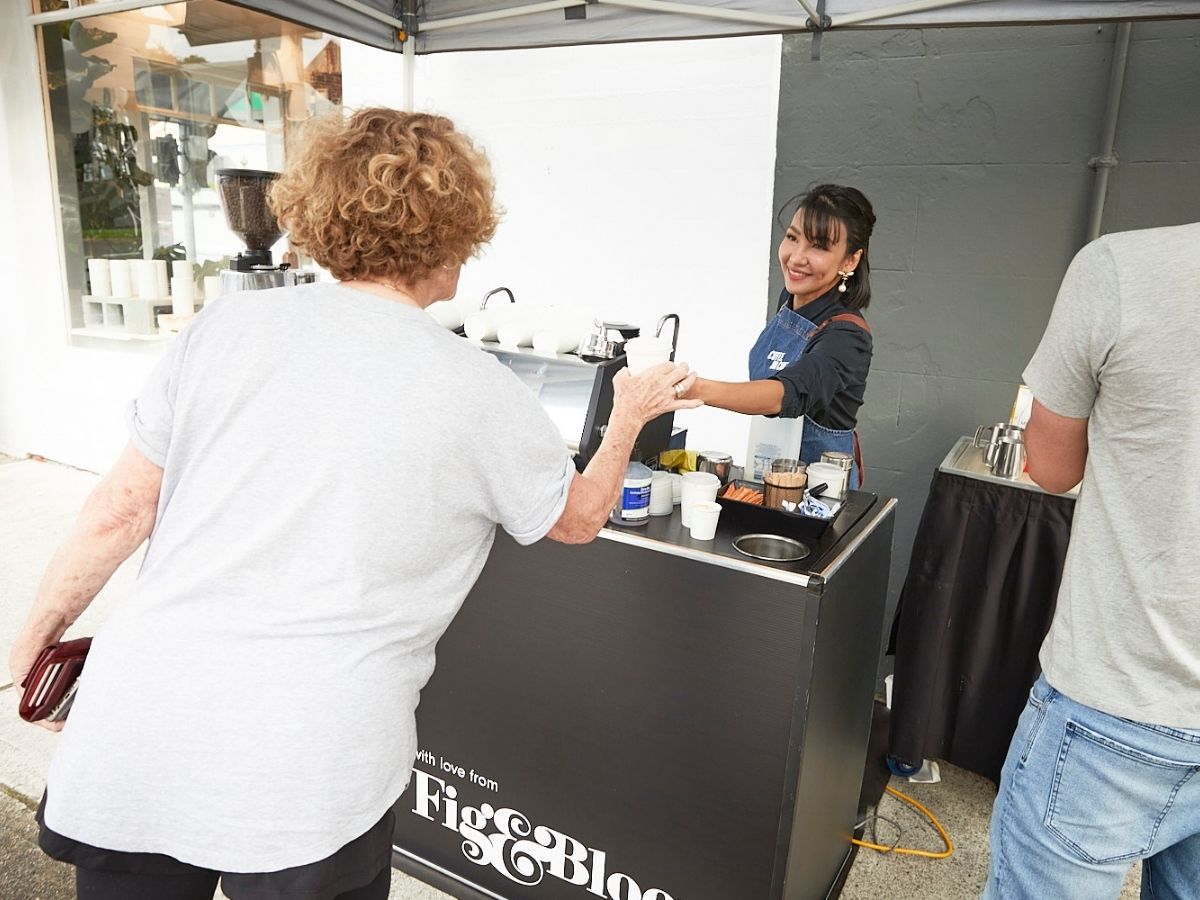 Barista handing coffee to event guest