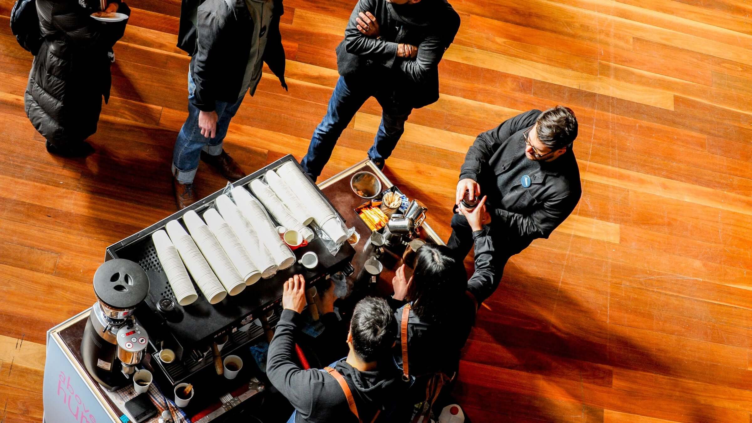 Baristas serving coffee to conference delegates