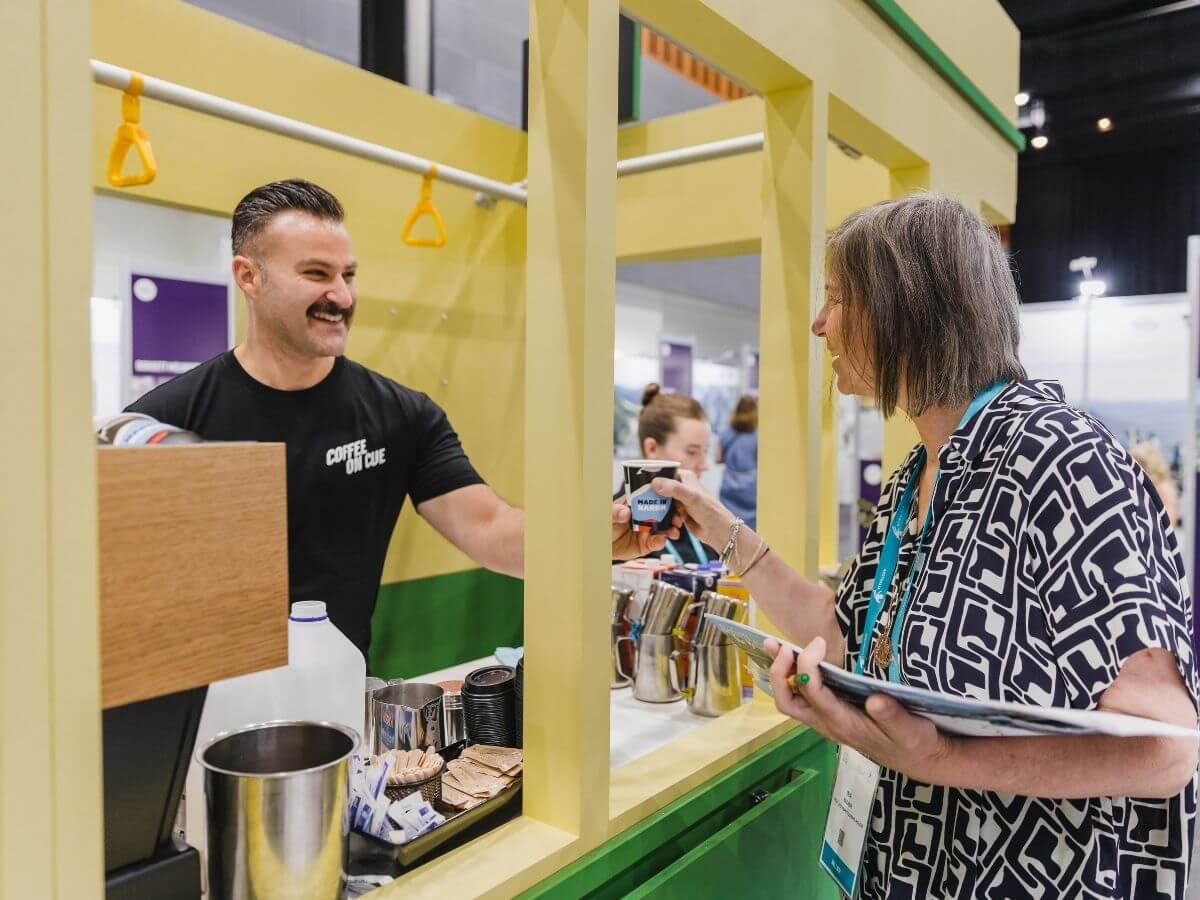 Barista passing coffee to event guest