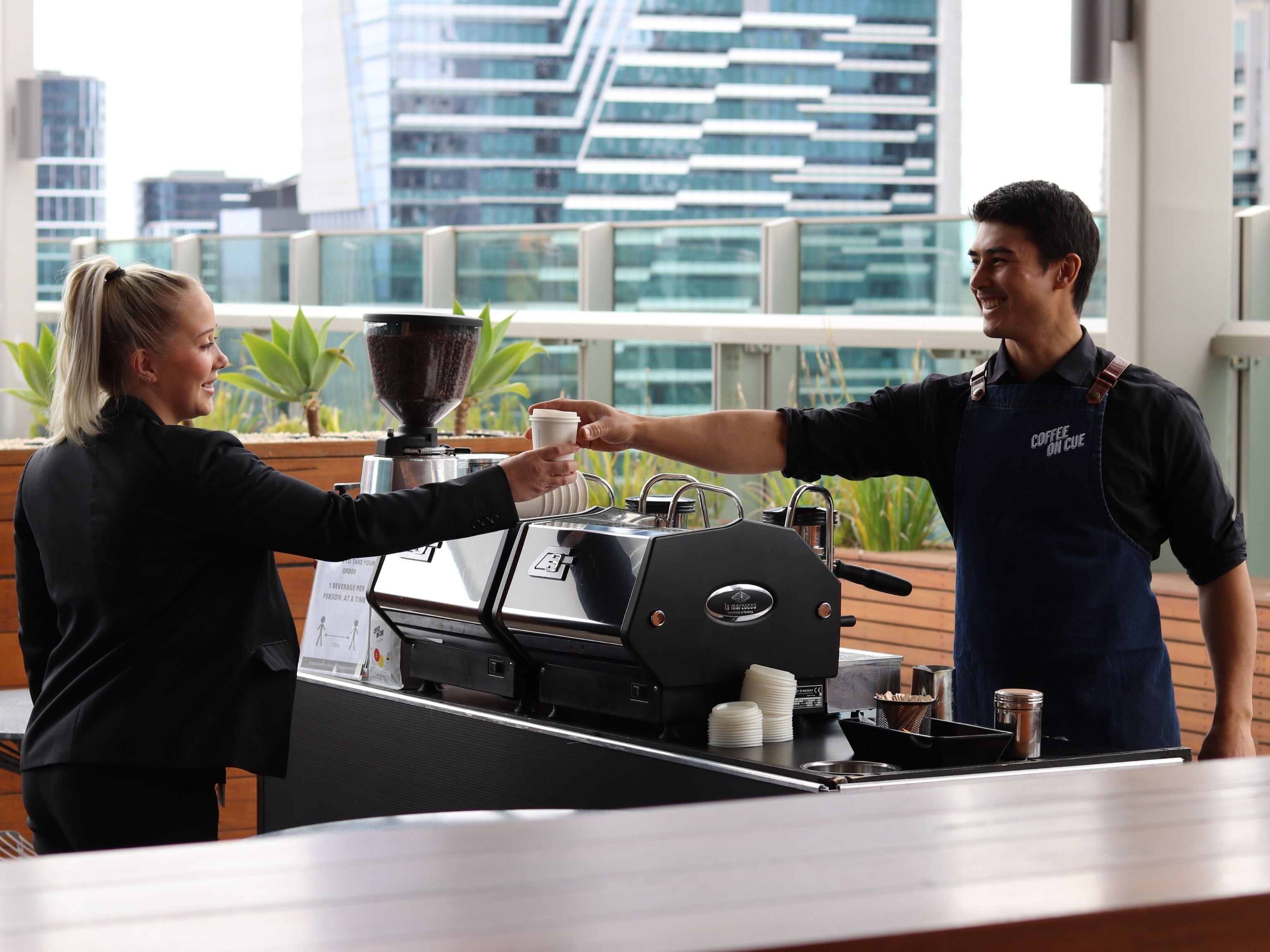 Event barista serving corporate employee
