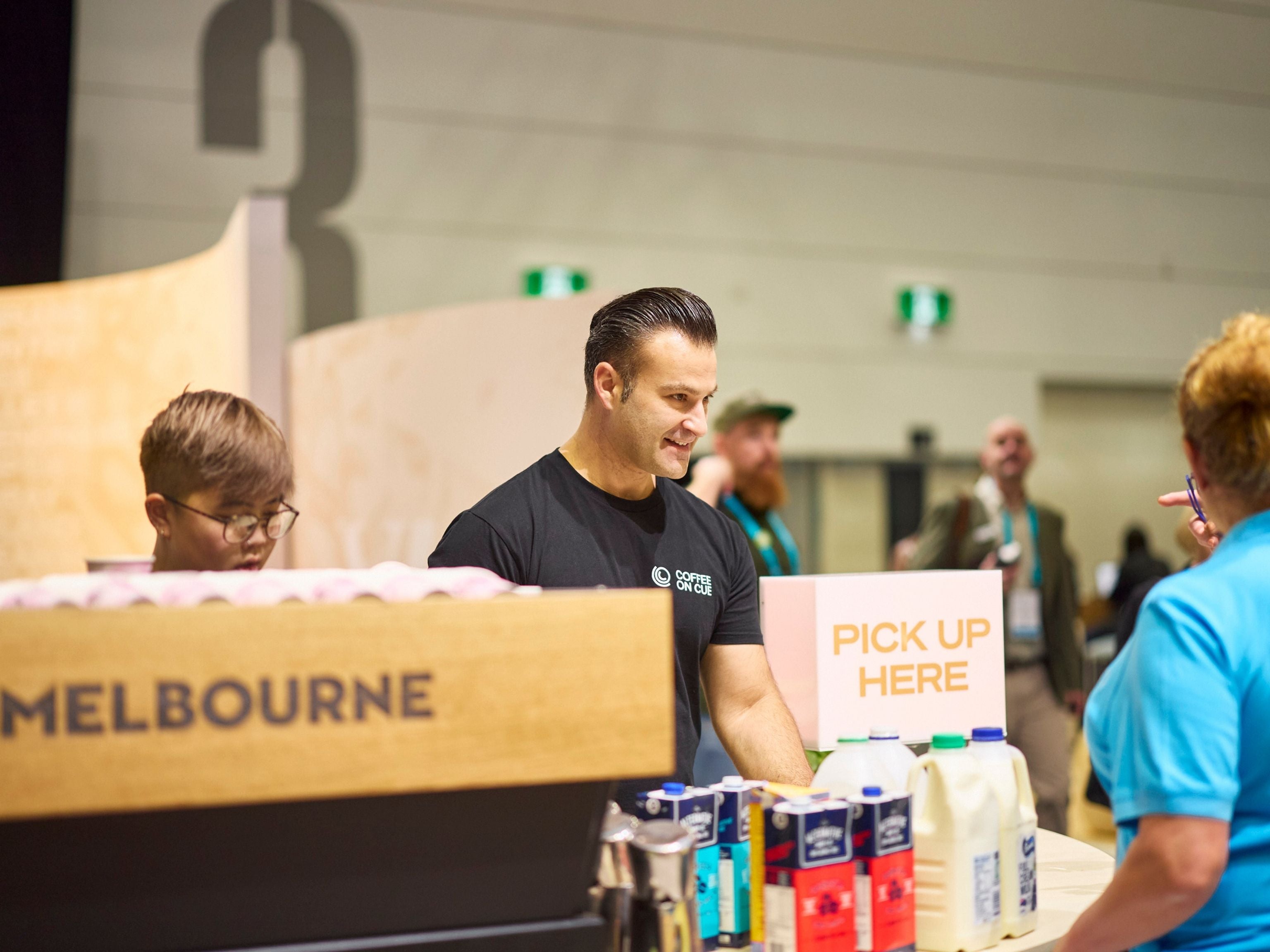 Melbourne barista serving trade show attendee