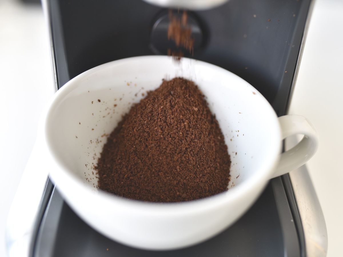 Coffee grounds falling into cup