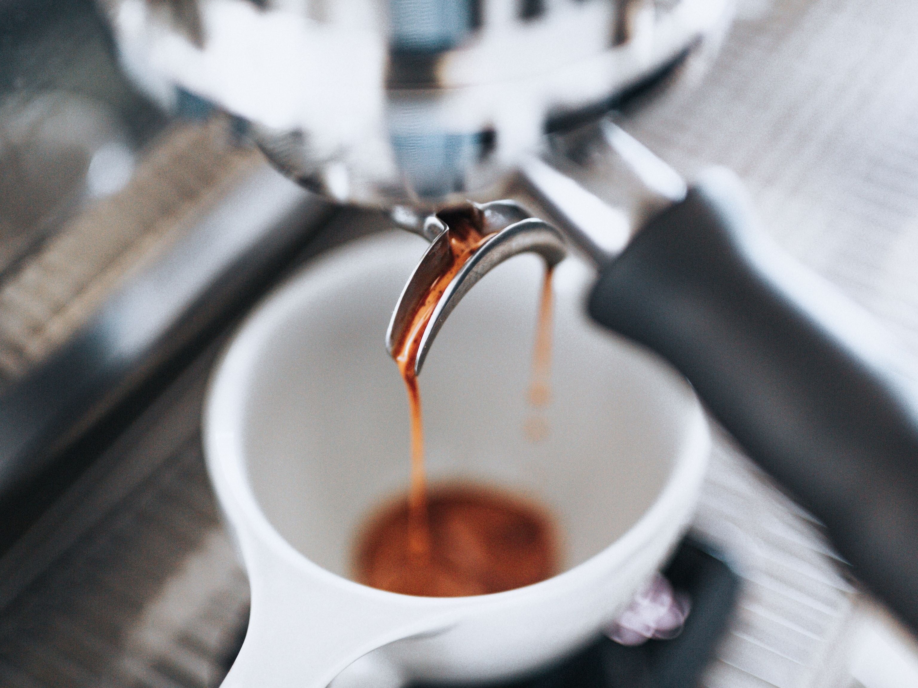 Espresso extraction pouring into cup