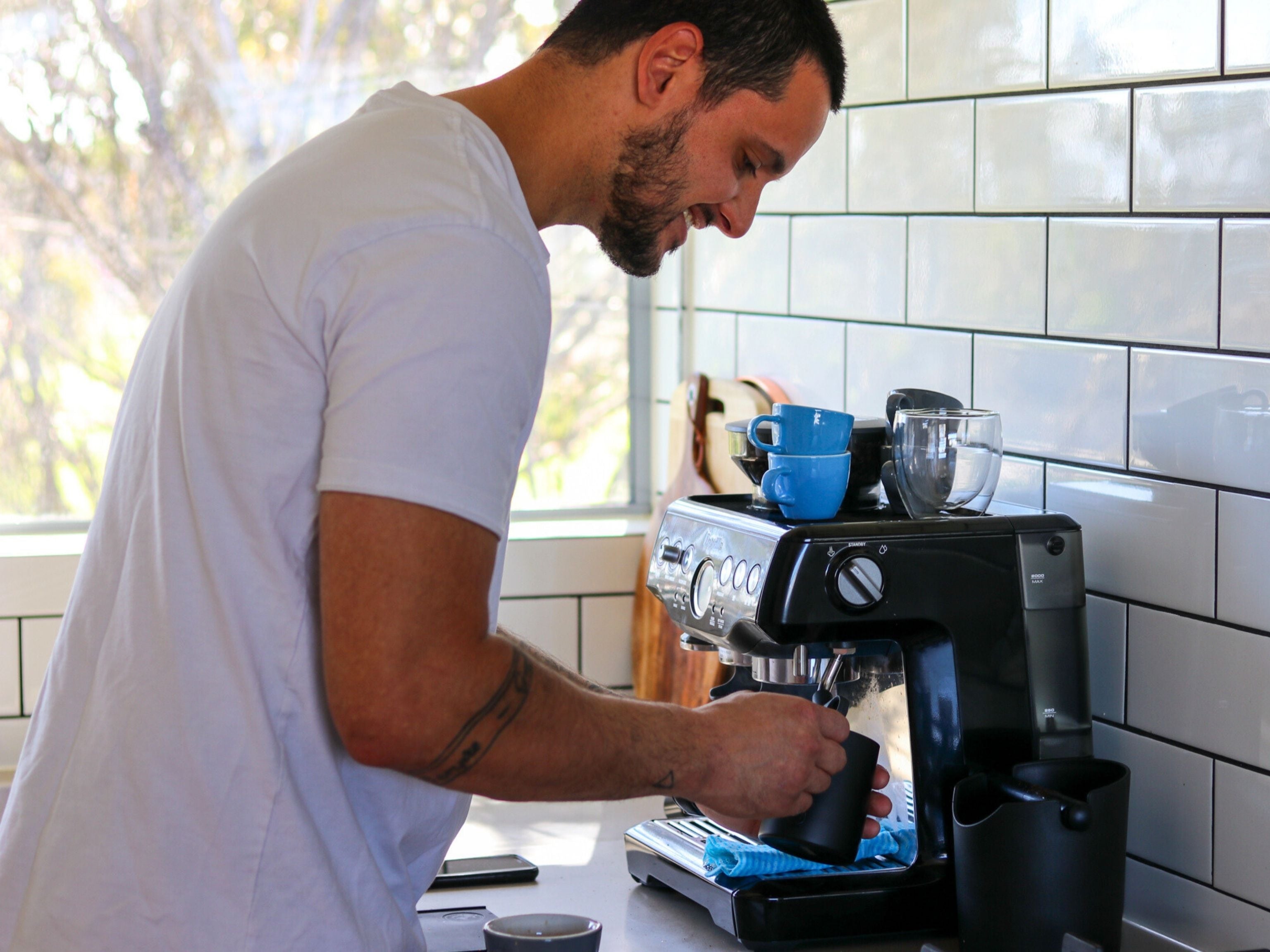 Man brewing espresso coffee at home