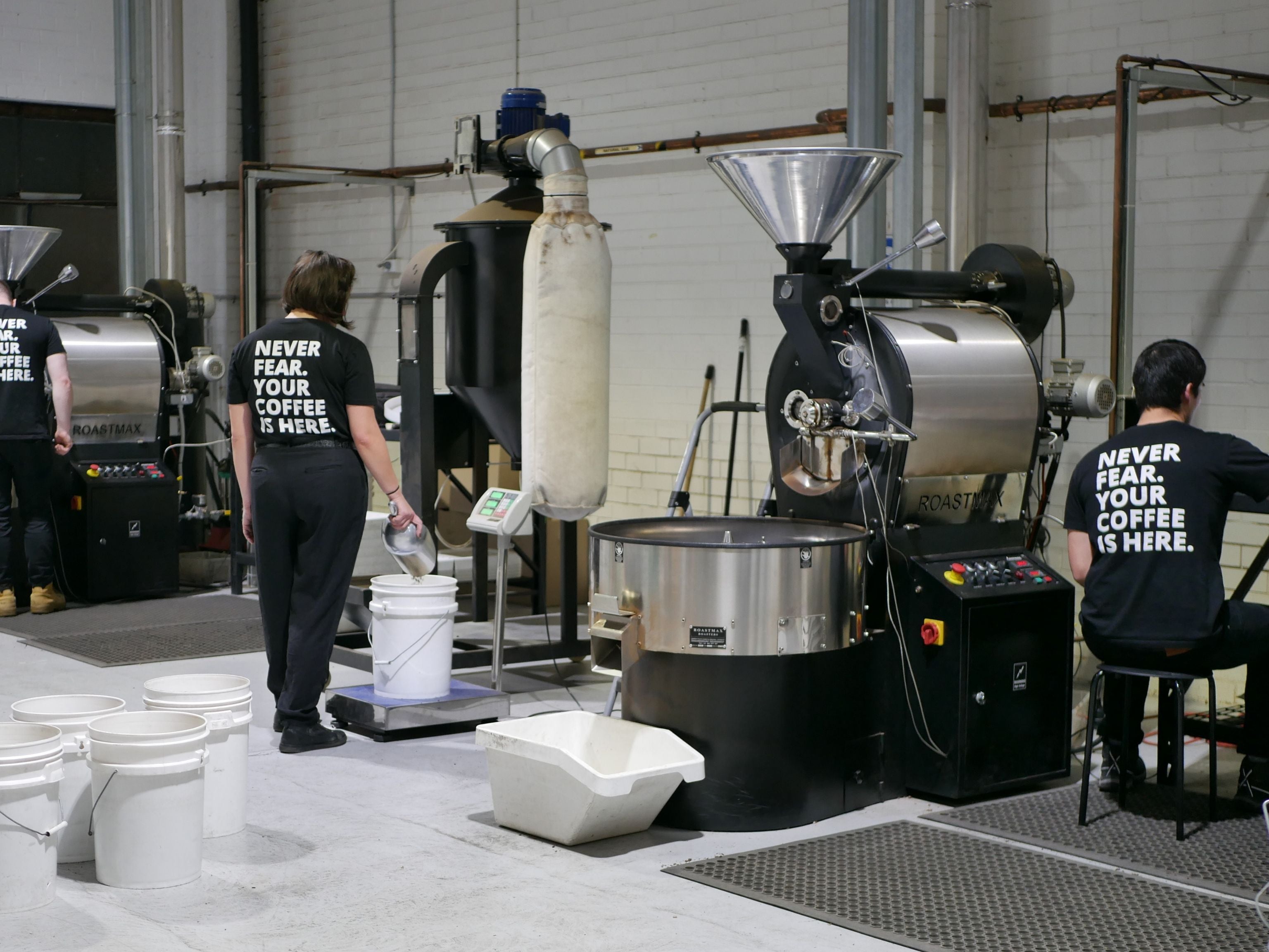 Roasting team roasting coffee at roastery