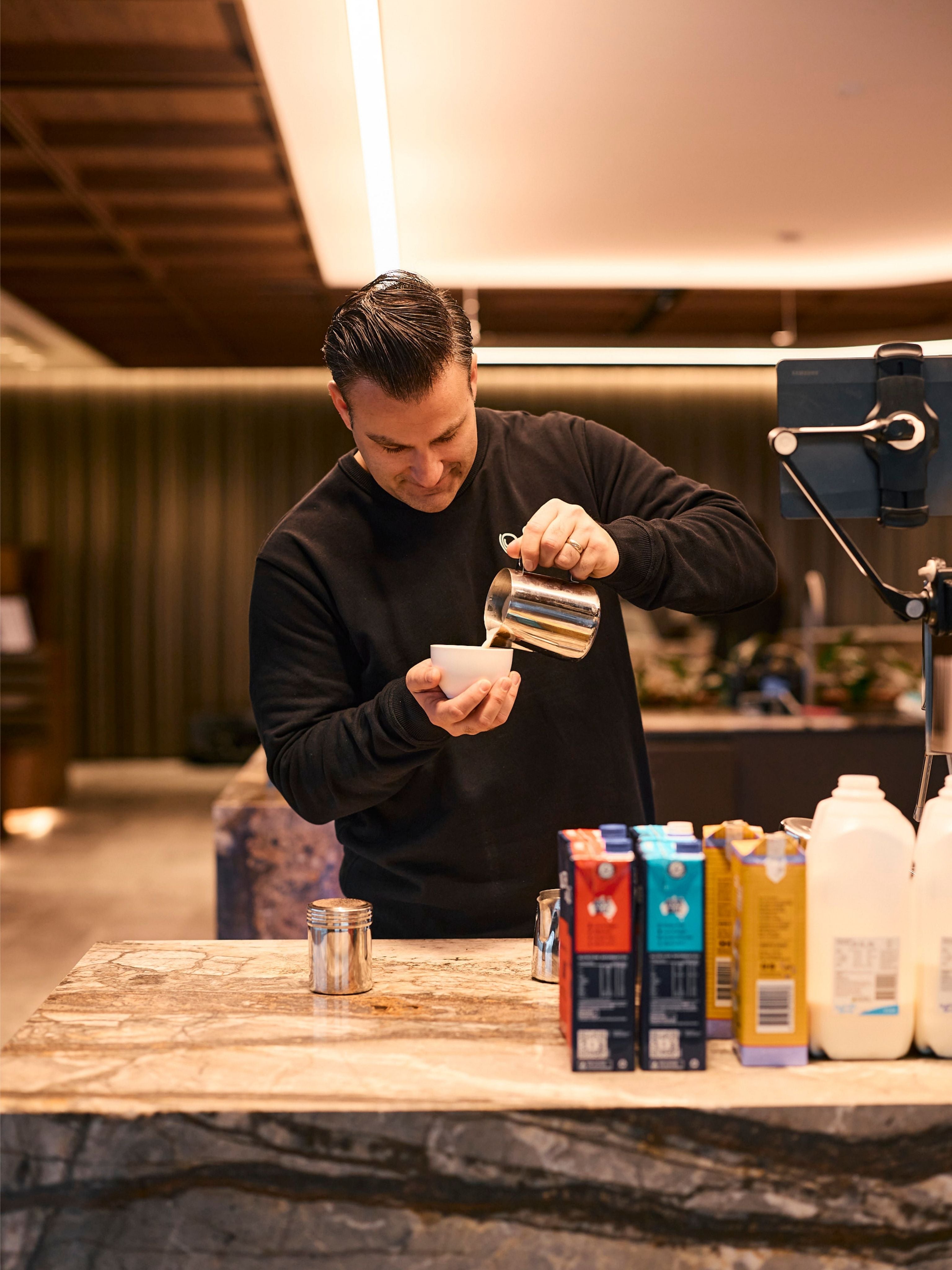 Ryan pouring a latte