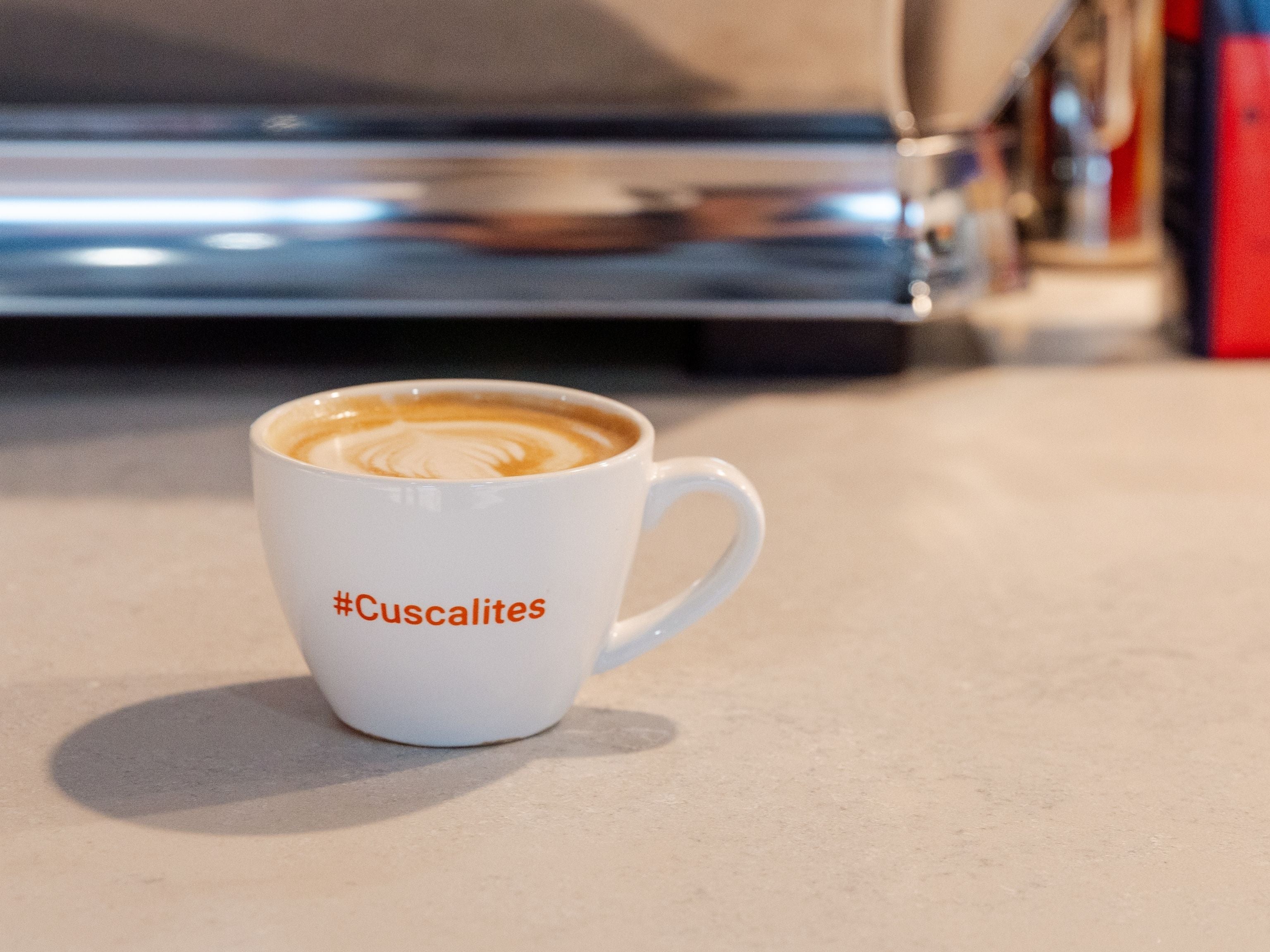 Cuscalites branded mug at workplace site
